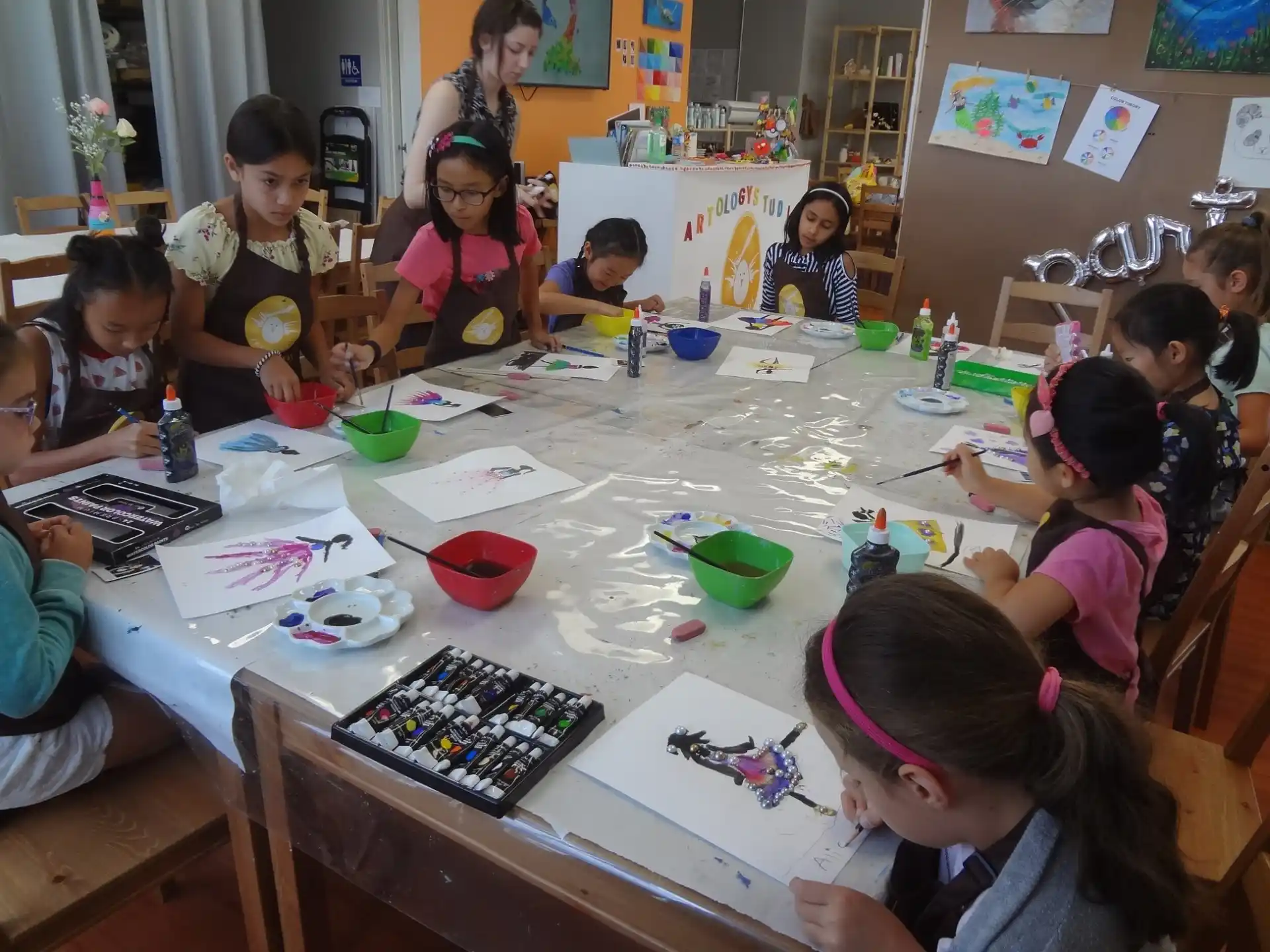 a group of children sitting around a table
