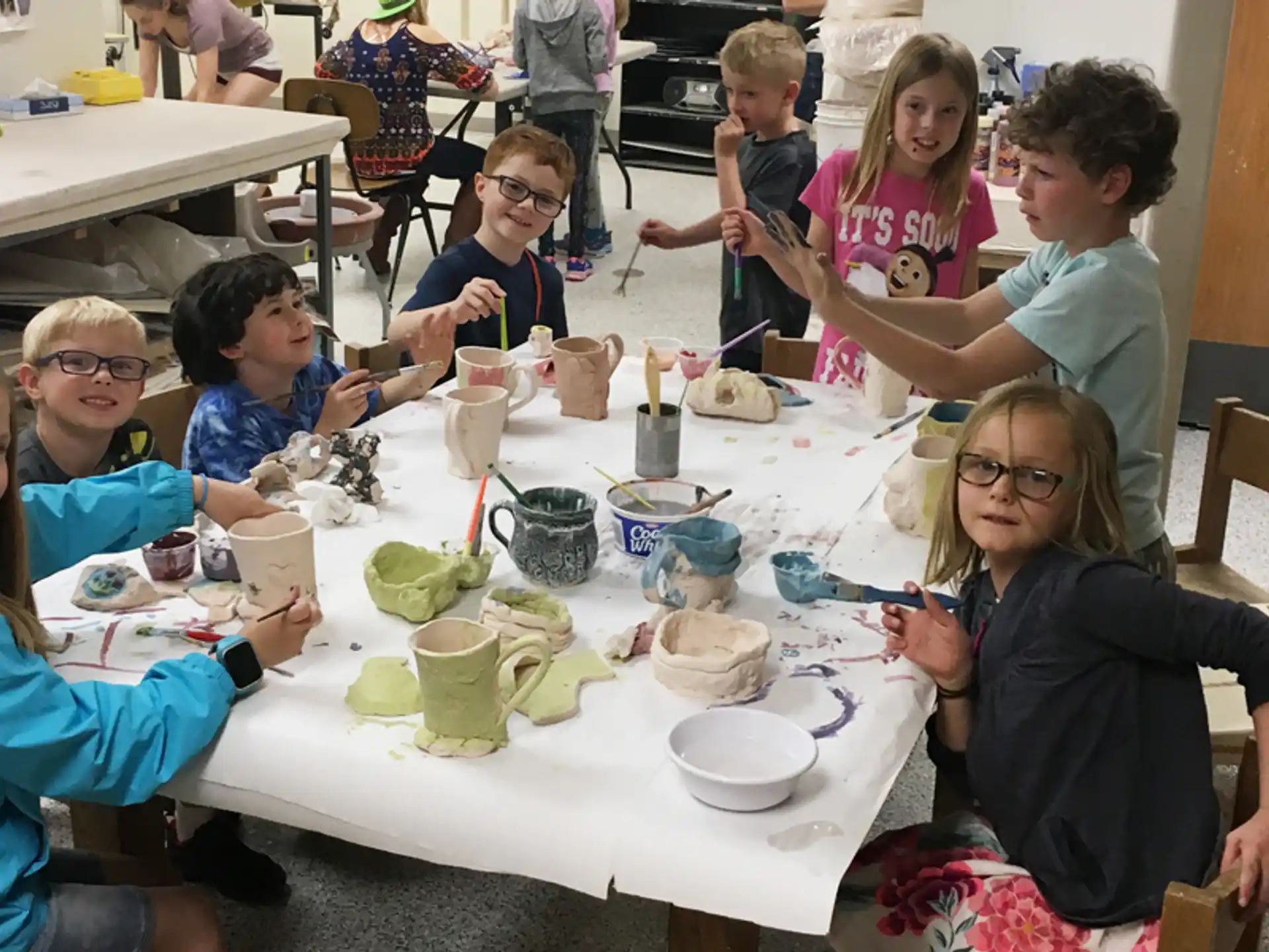 a group of children sitting around a table