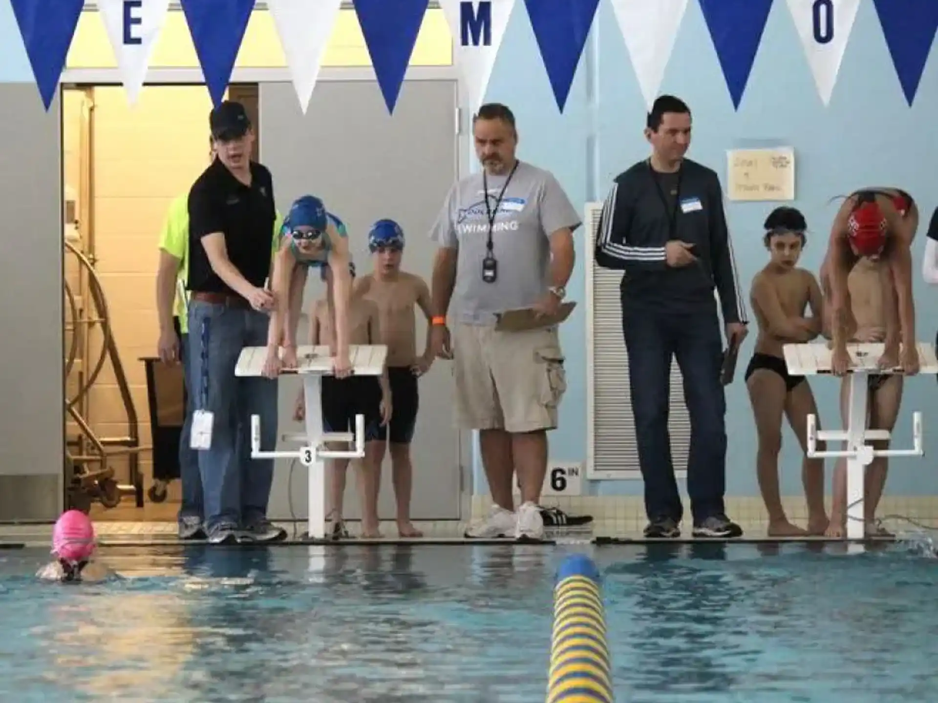 a group of people standing in a pool