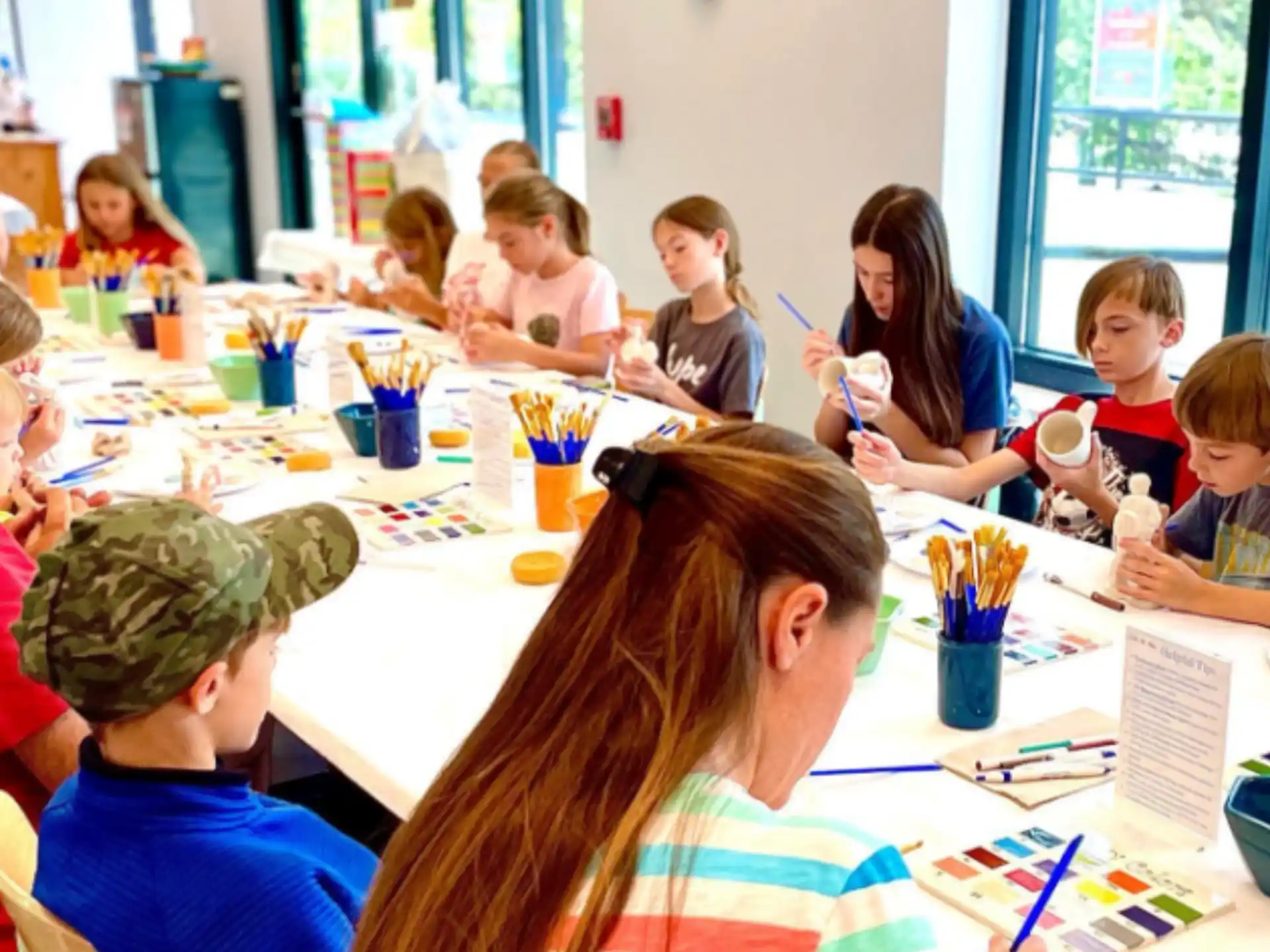 a group of children sitting around a table