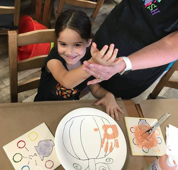 a person and a child sitting at a table
