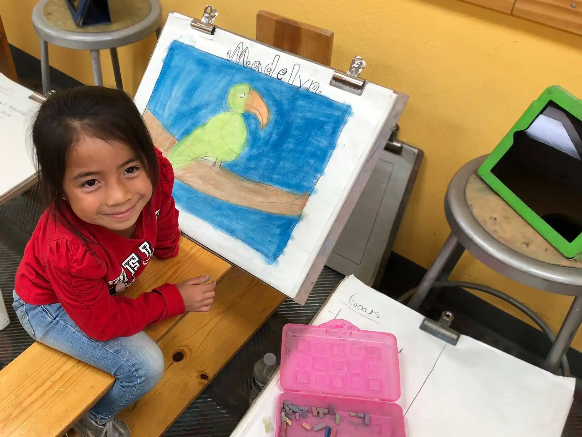 a girl painting on a canvas