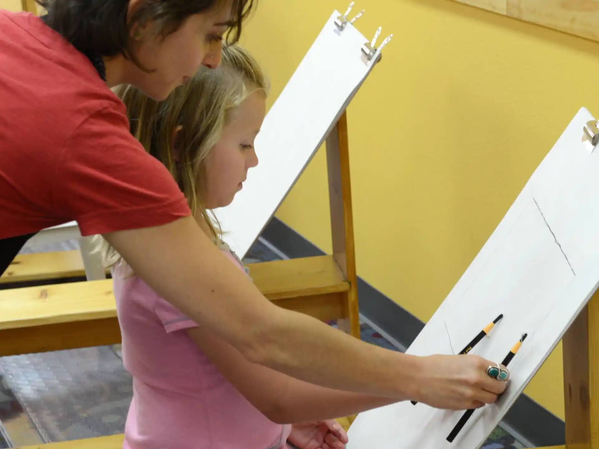 a person drawing on a white board