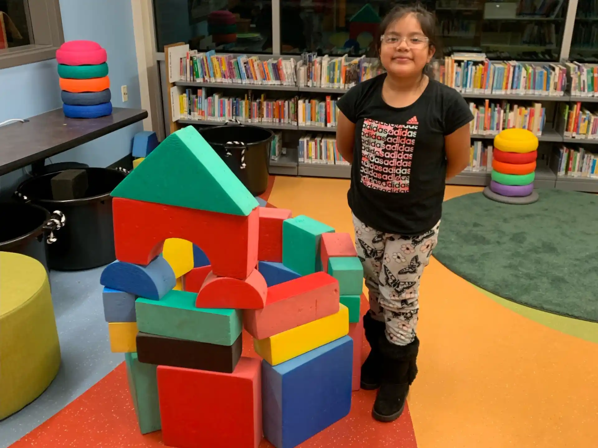 a child standing next to a toy