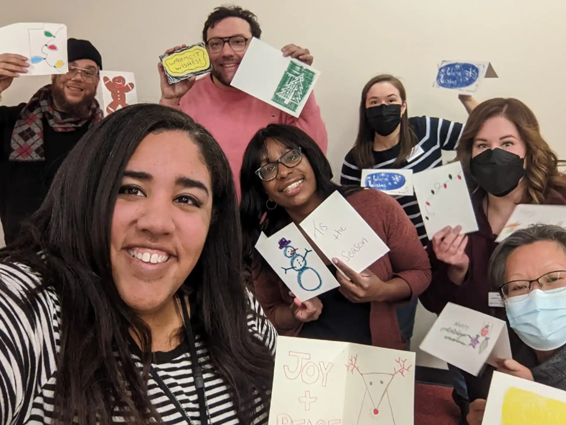 a group of people holding up paper