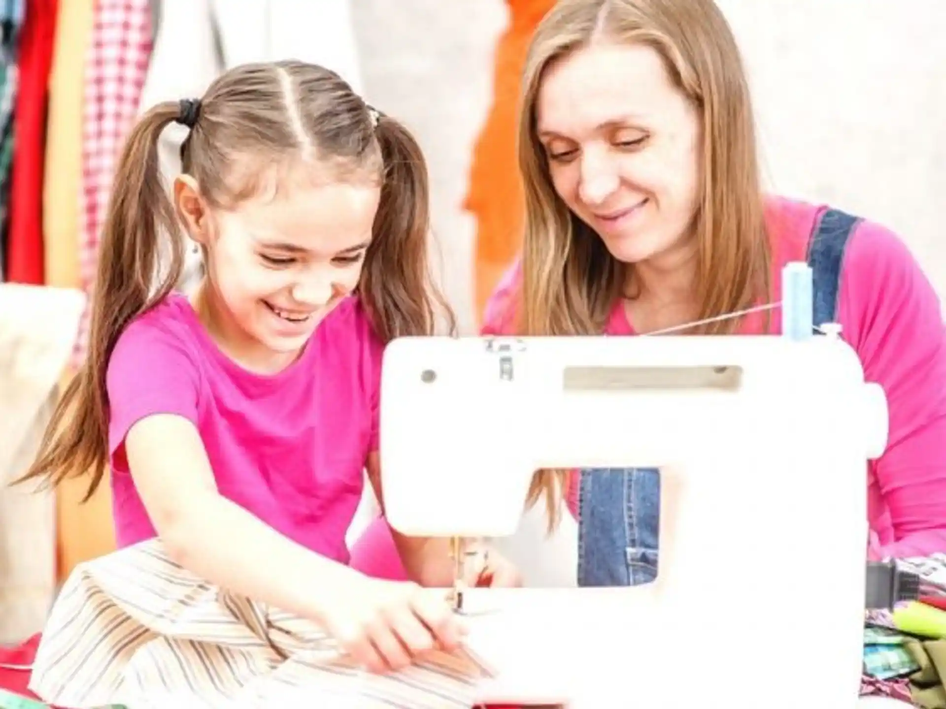 a person and a girl looking at a tablet