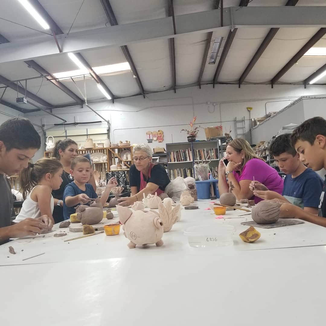 a group of people sitting at a table with a large white table with a white tablecloth and
