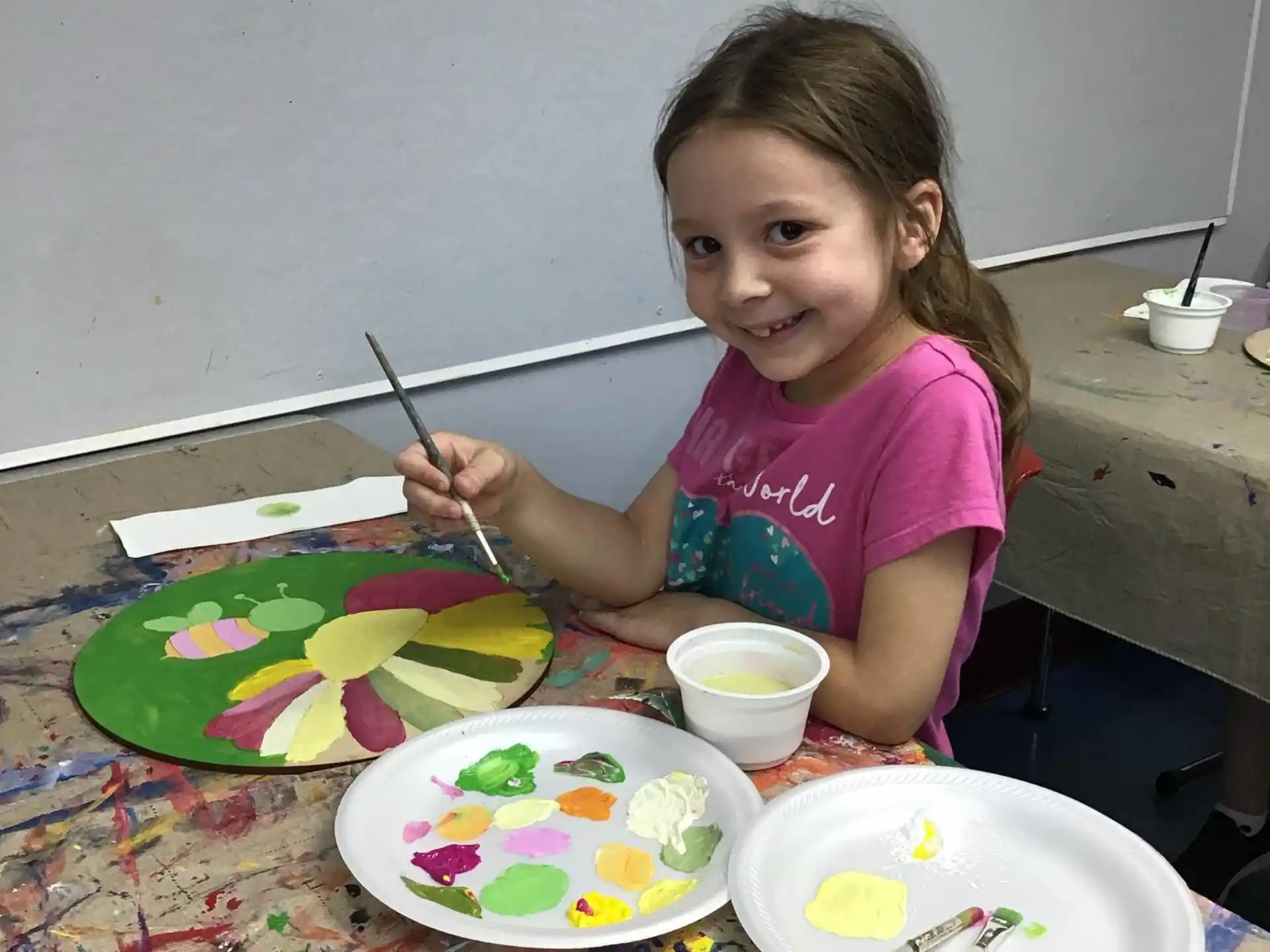a girl painting on a table