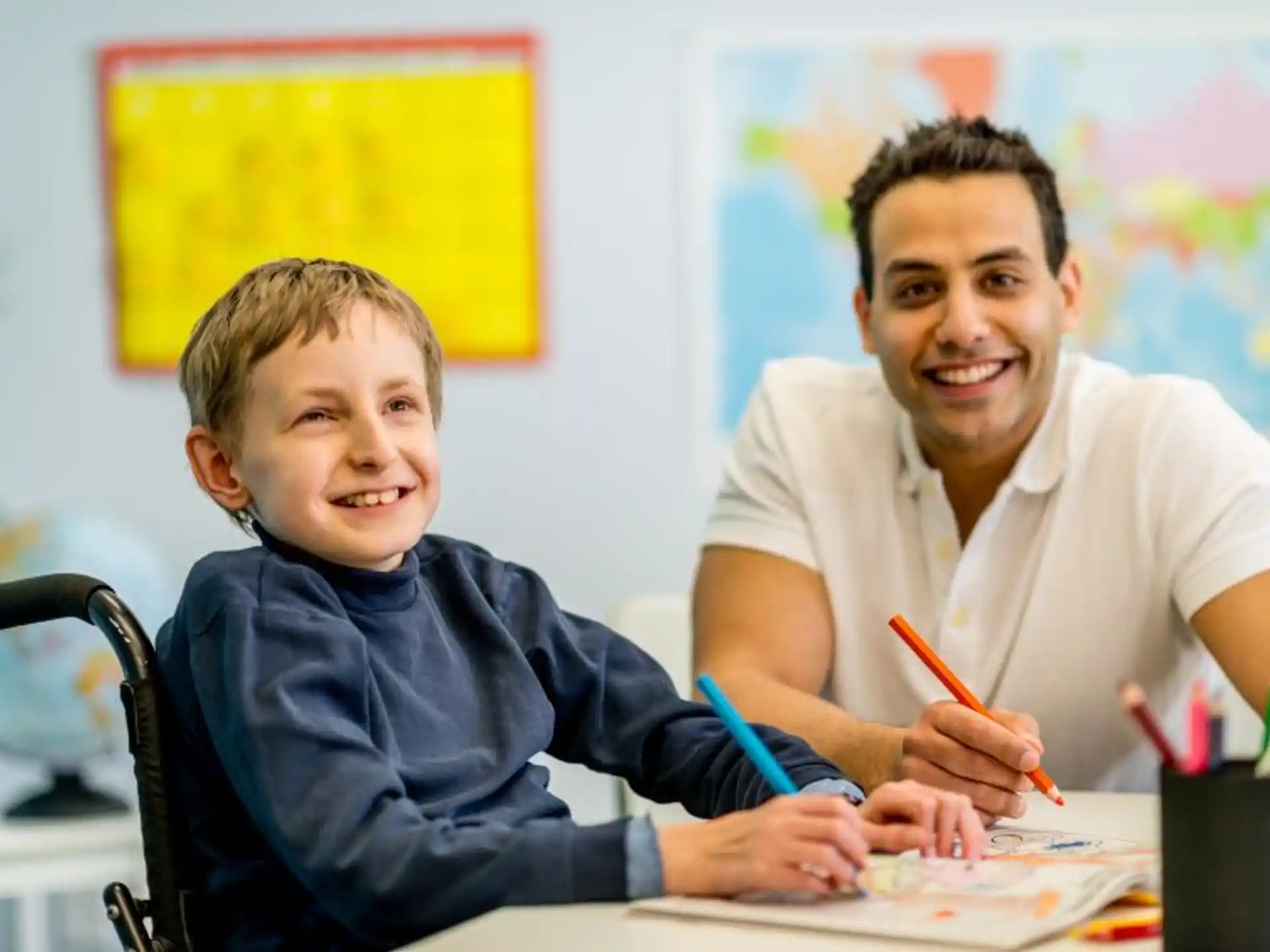 a person and a boy sitting at a table