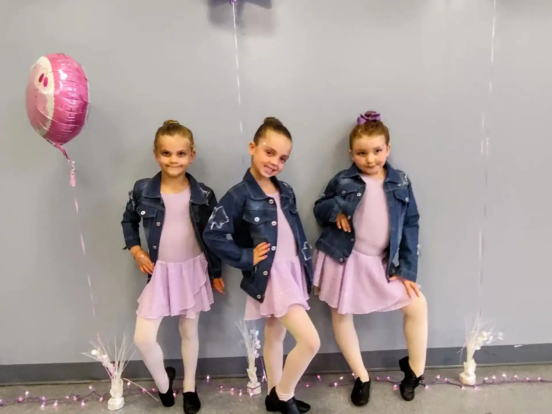 a group of girls in dresses and a balloon