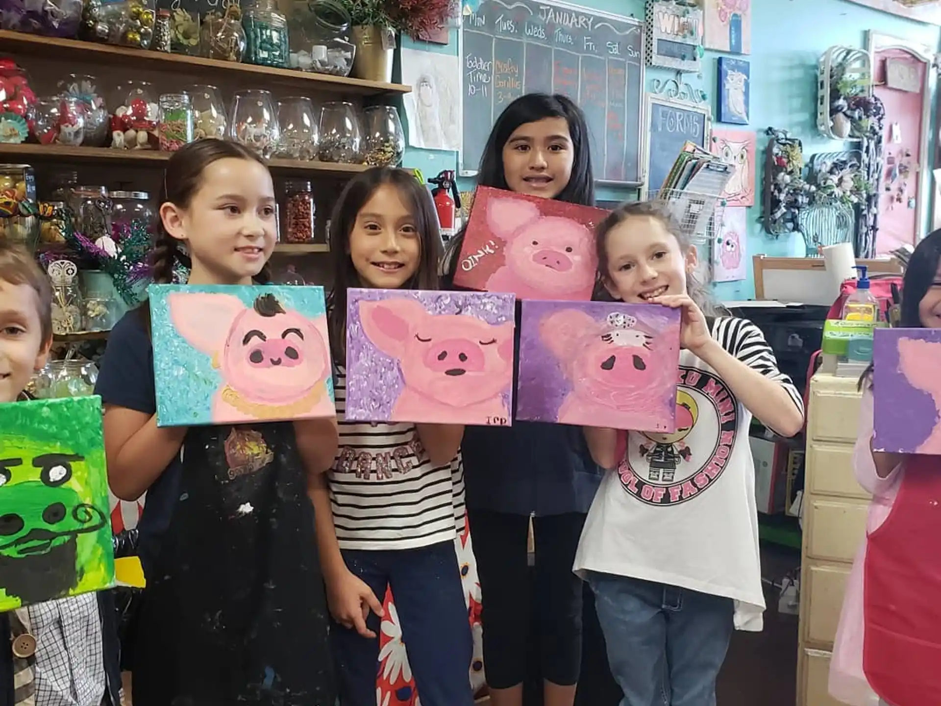 a group of children holding up paper hearts