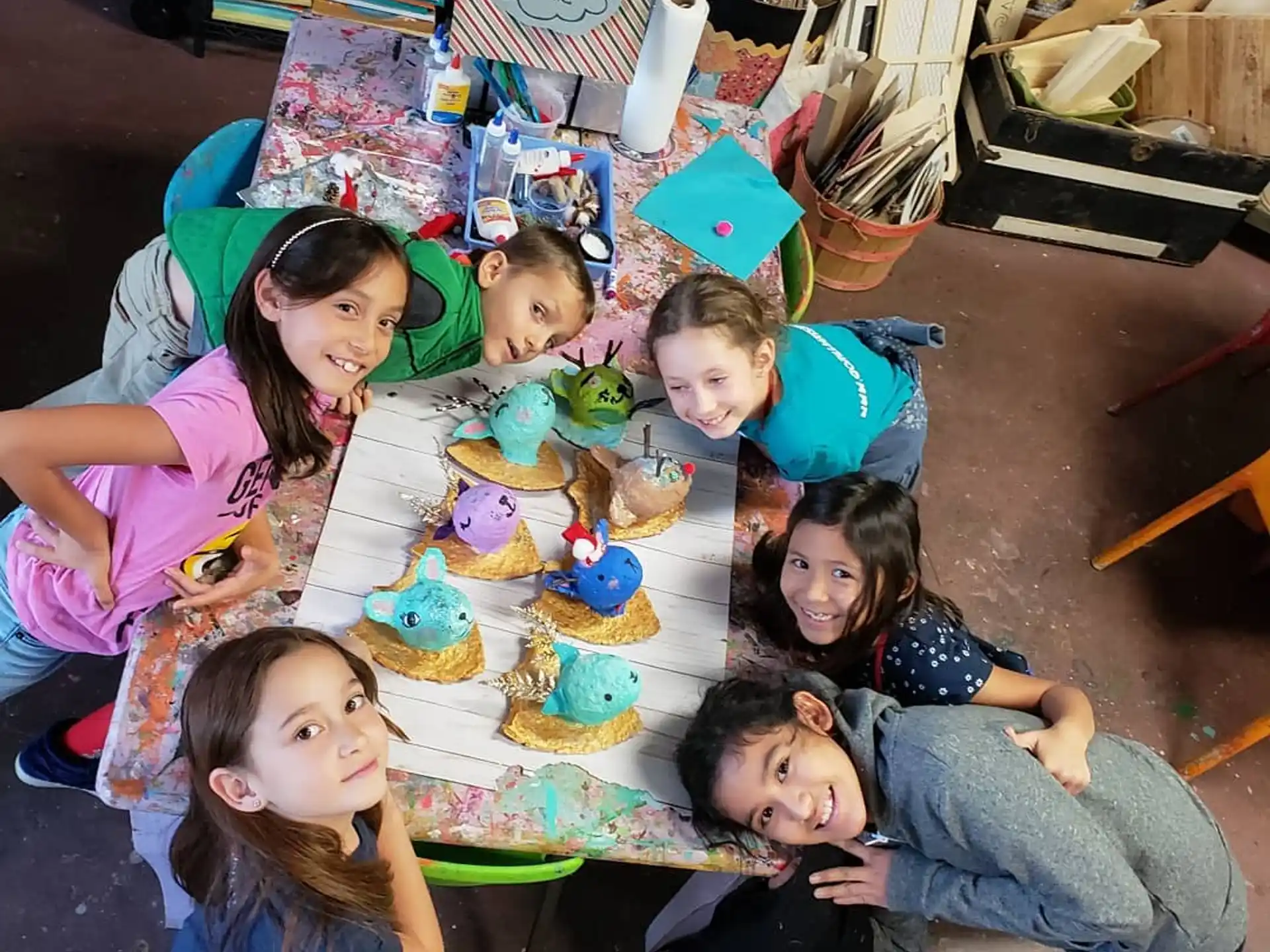 a group of children sitting around a table