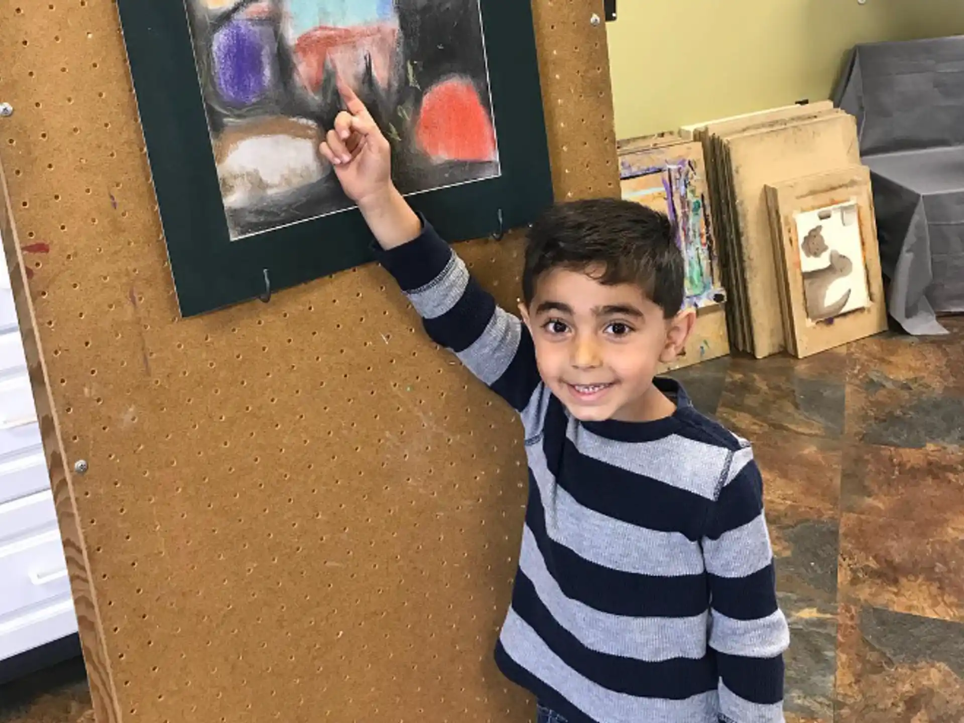 a boy holding his hand up