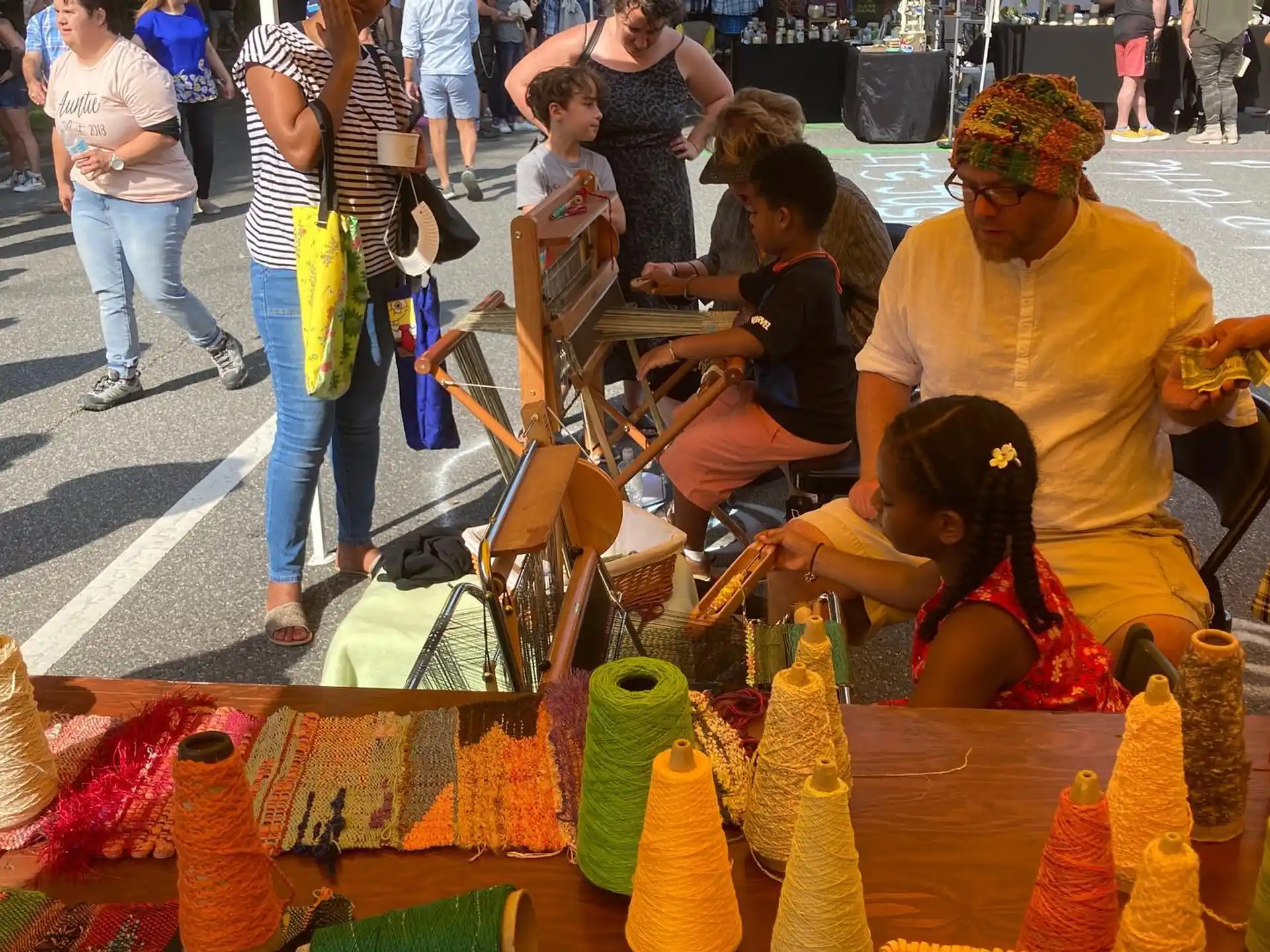 a group of people sitting at a table with objects on it