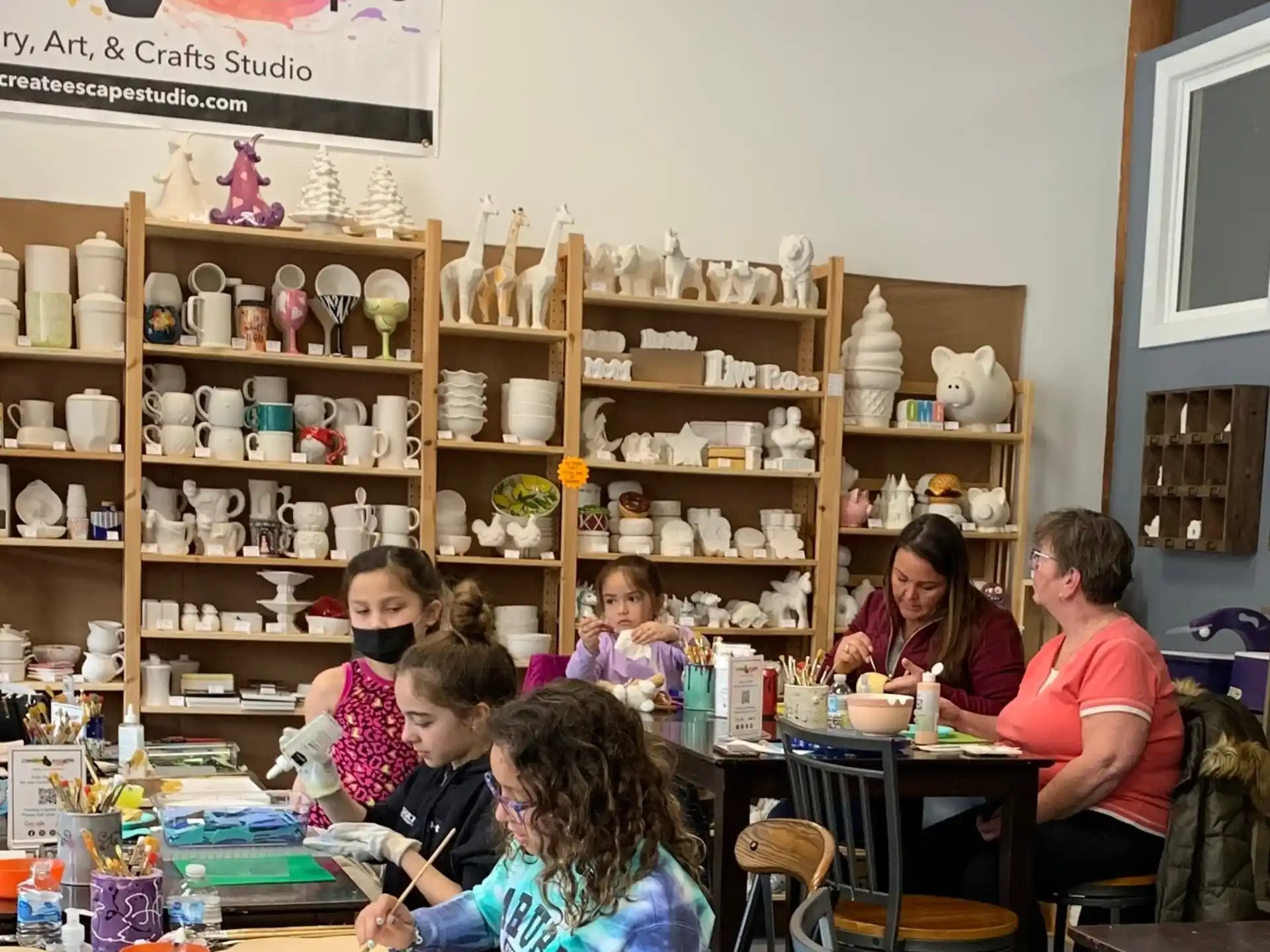 a group of people sitting at a table in a room with shelves
