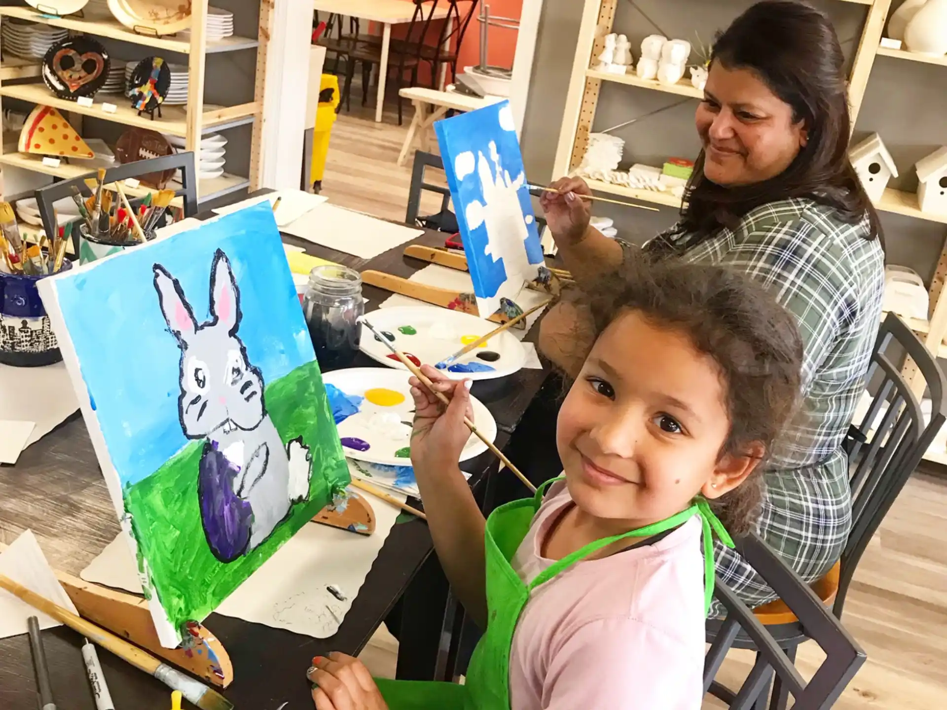 a person and a child painting