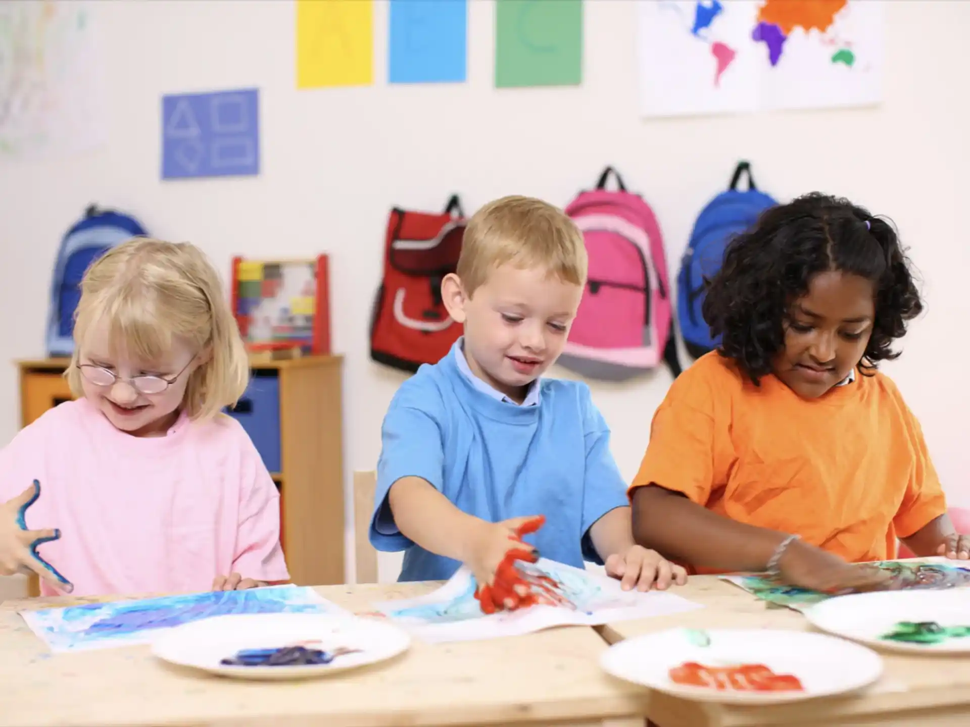 a group of children sitting at a table