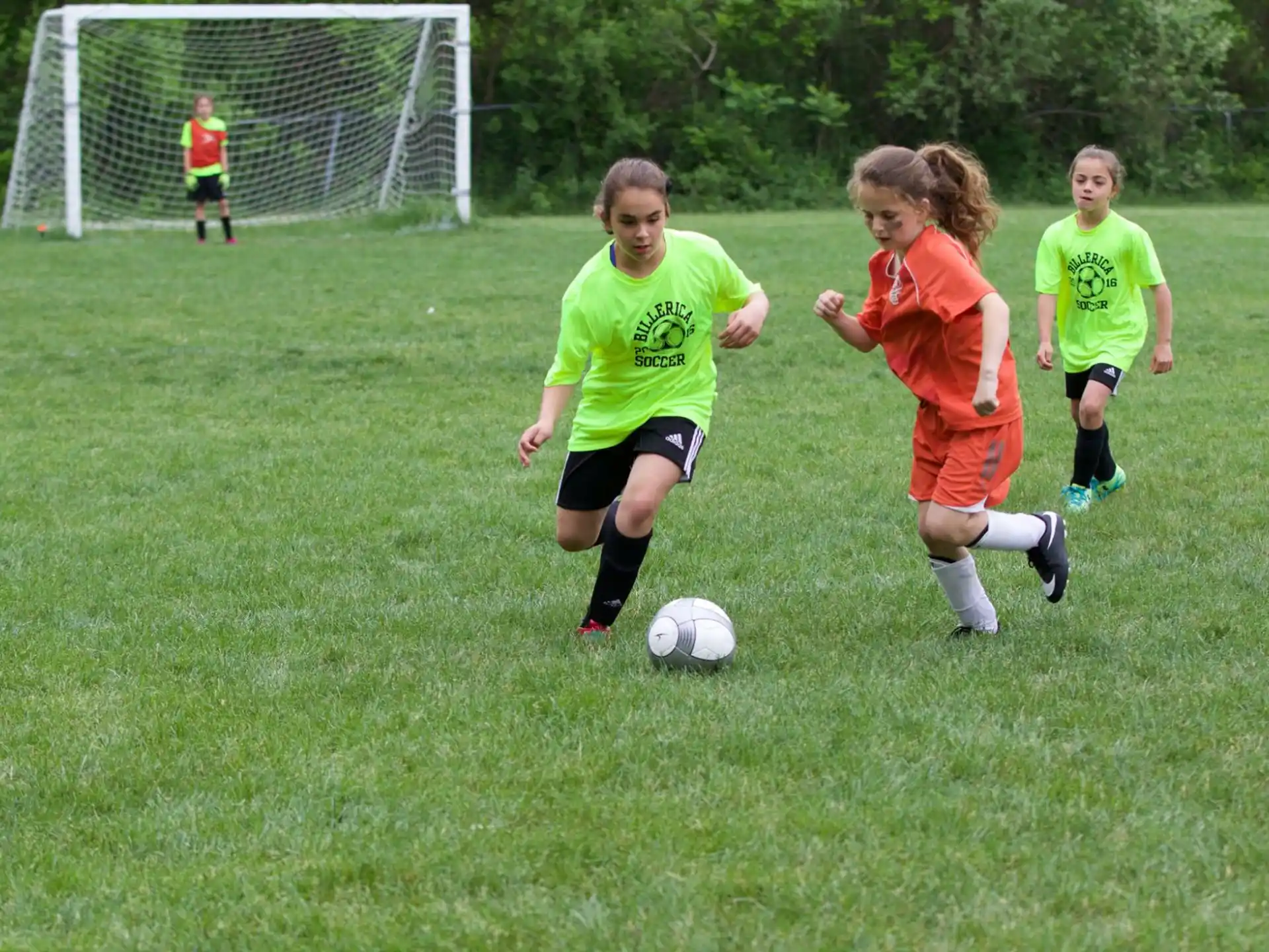 kids playing football on a field
