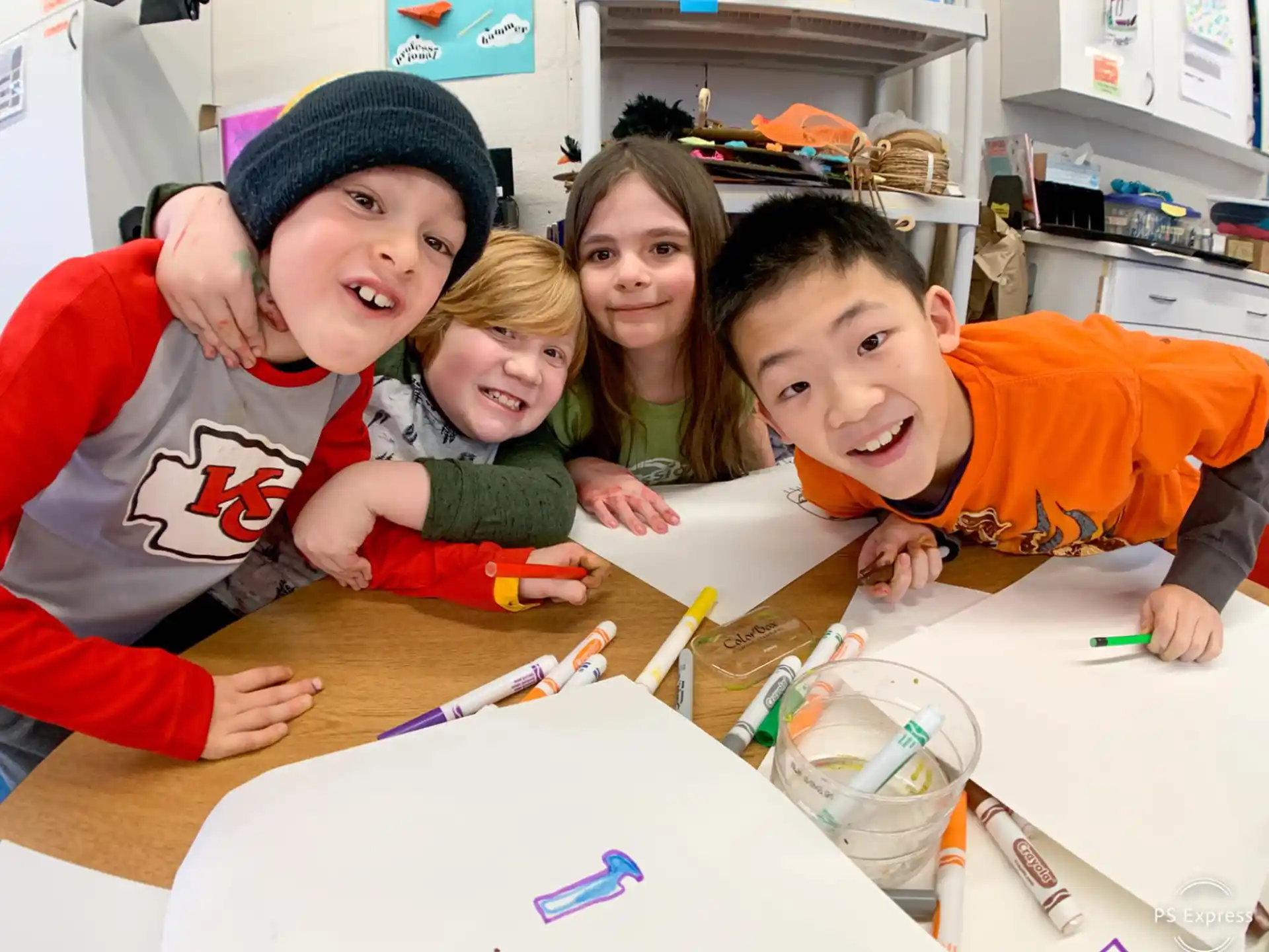 a group of kids sitting at a table