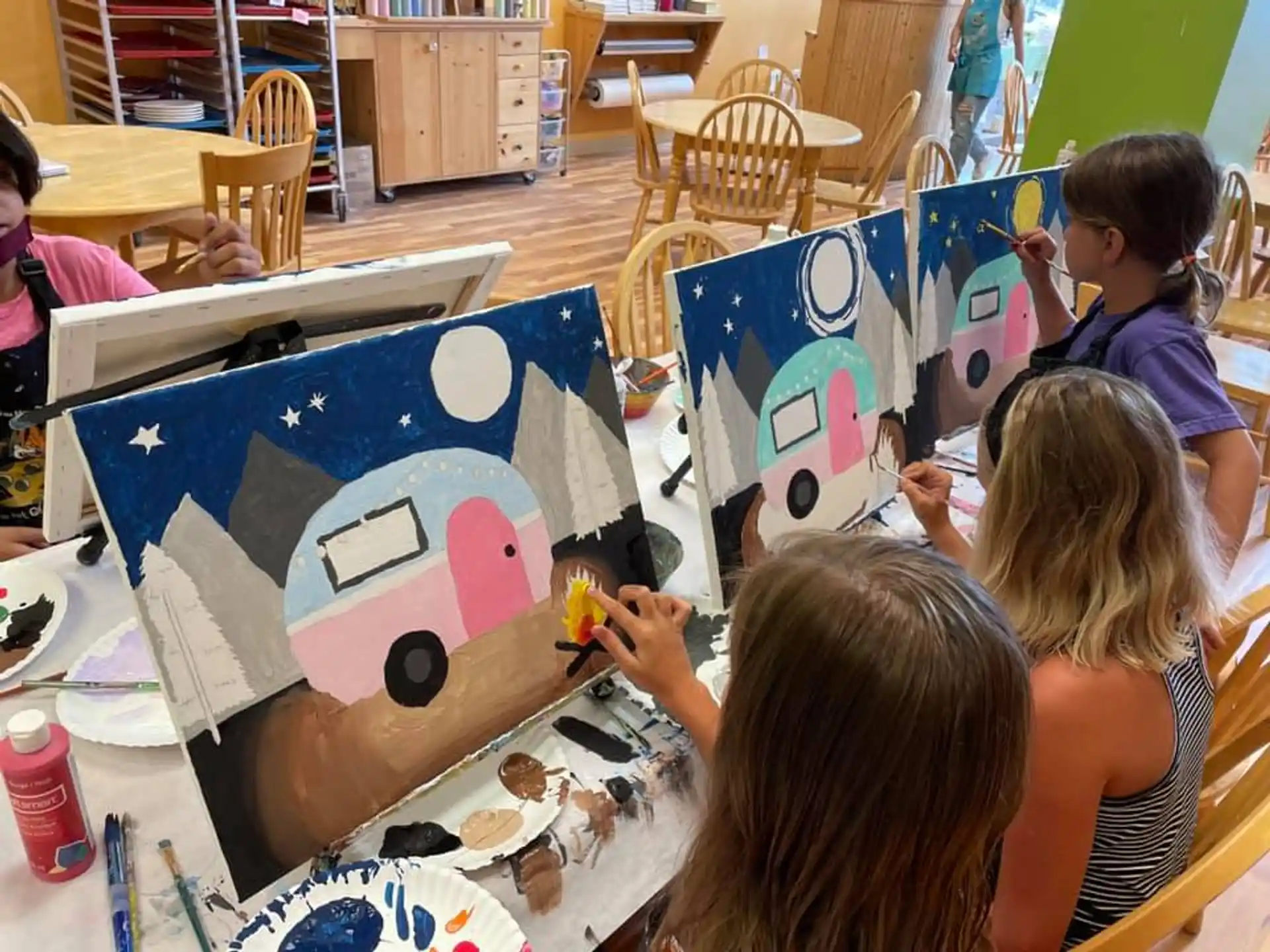 a group of children painting