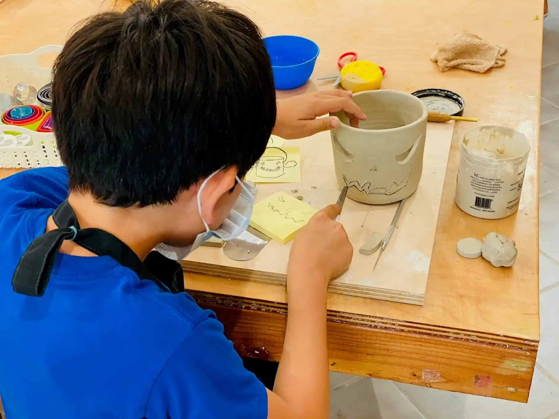 a boy painting on a table