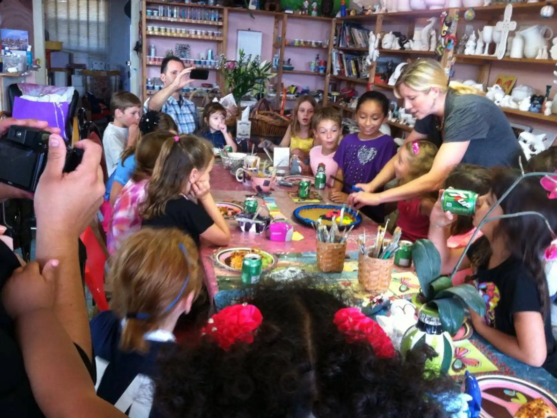 a group of people sitting around a table with food on it