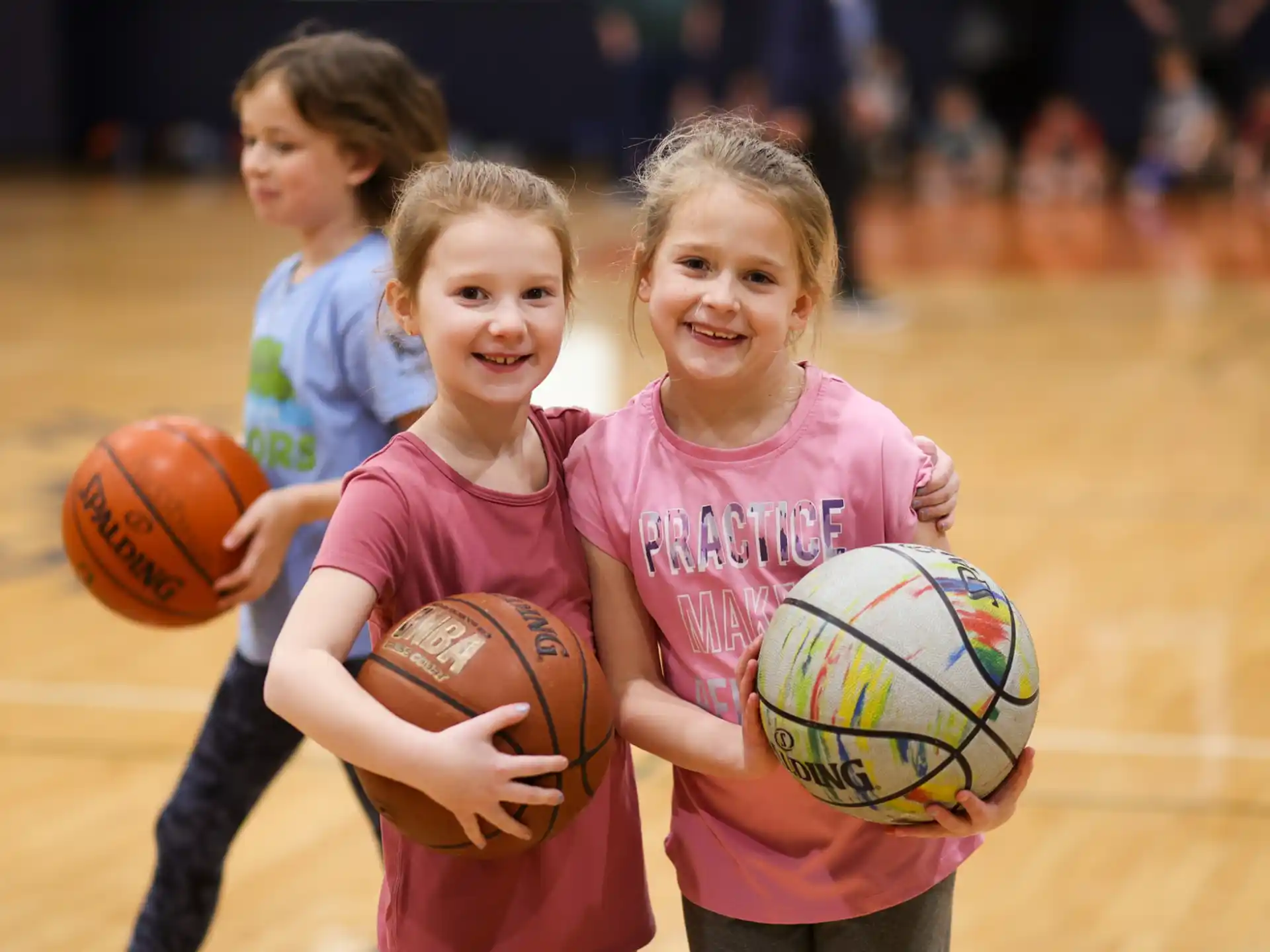 a group of girls holding basketballs