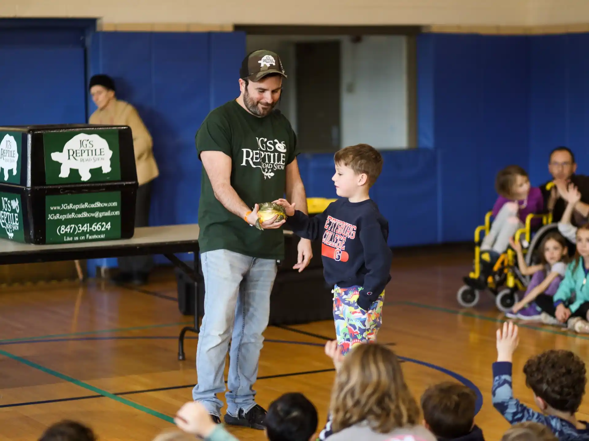 a person and a boy in a gym