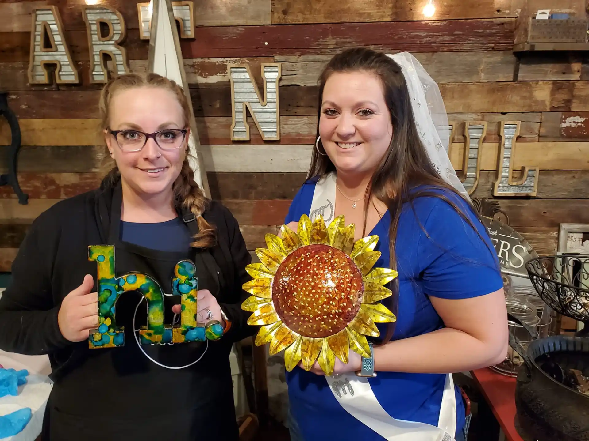 a couple of women holding a large colorful object