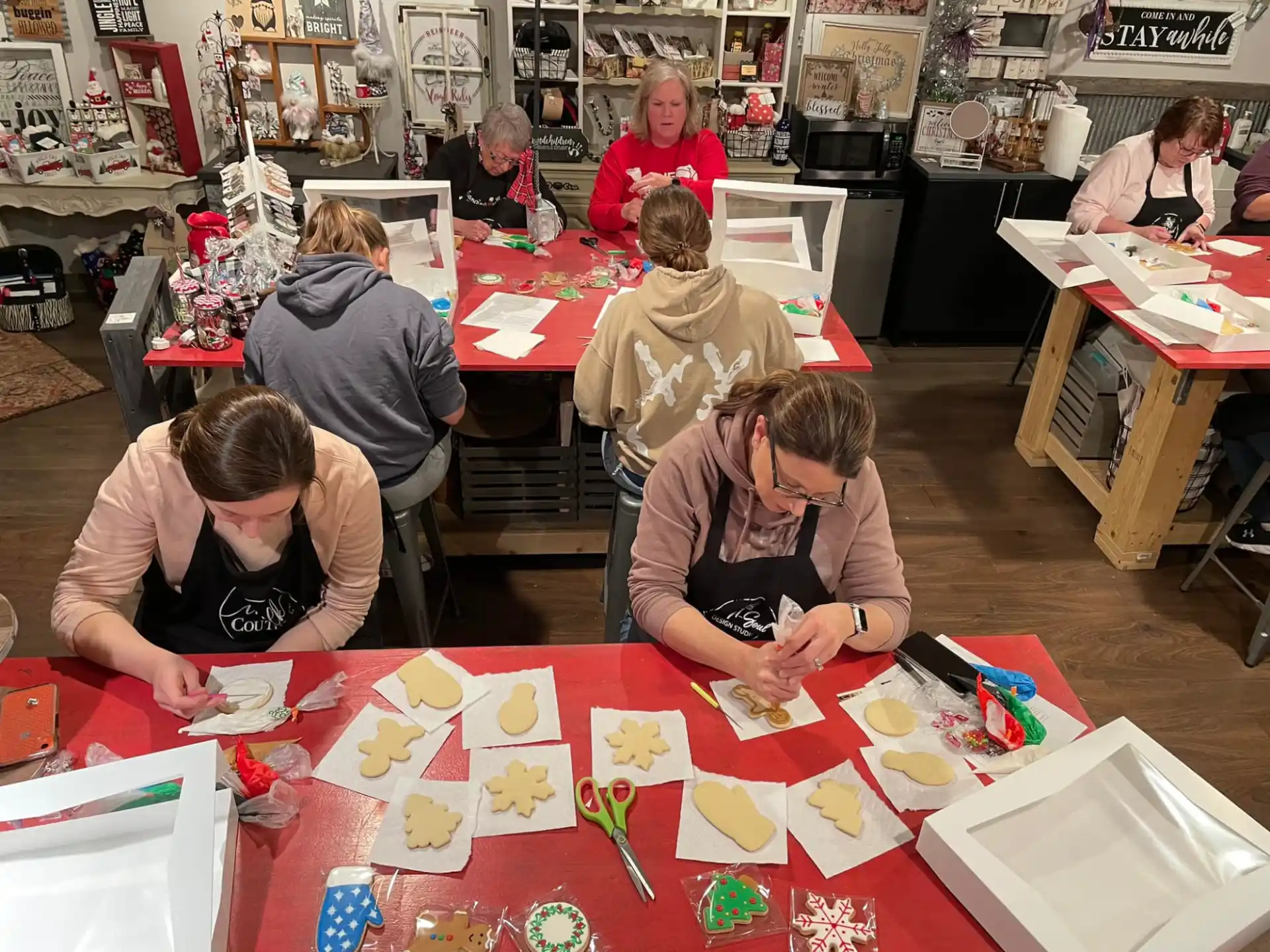 a group of people sitting at a table with drawings on it