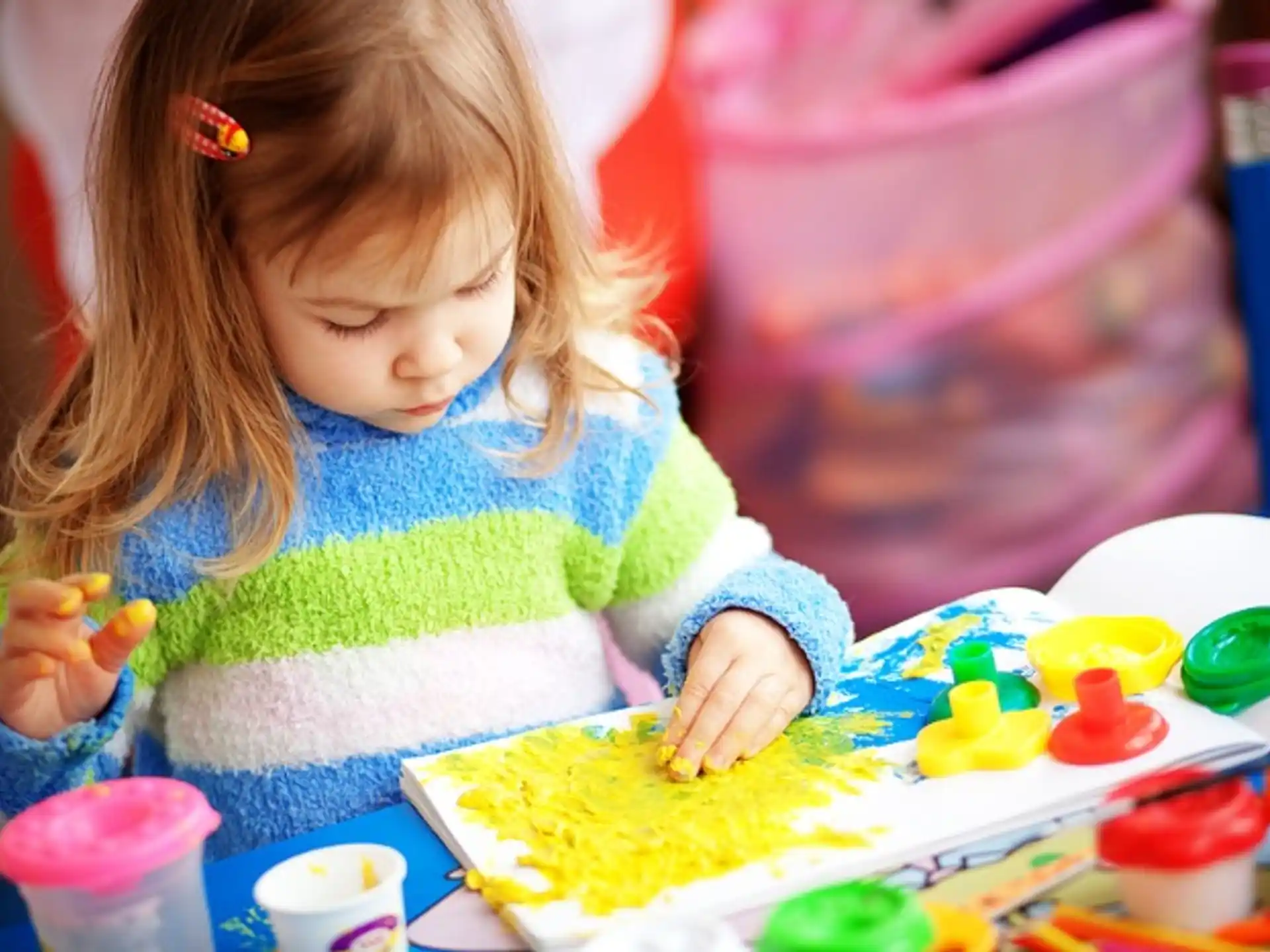 a little girl playing with toys