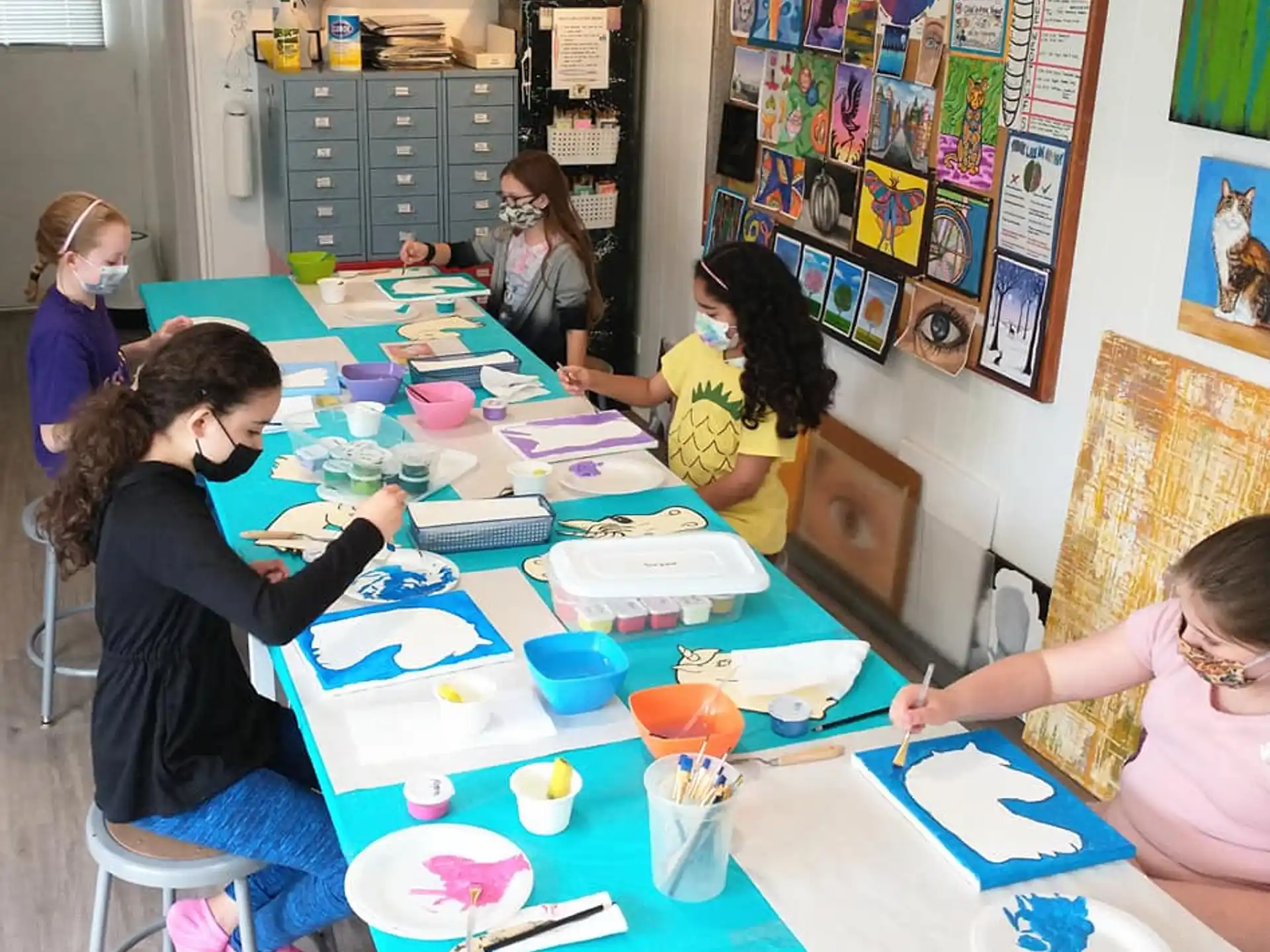 a group of children painting