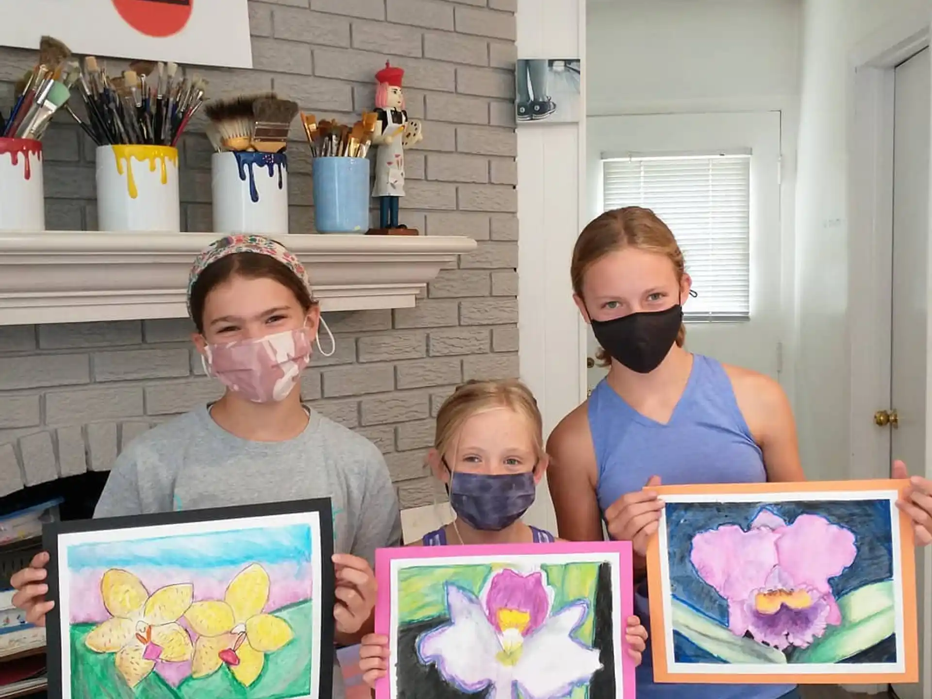 a group of kids holding framed pictures