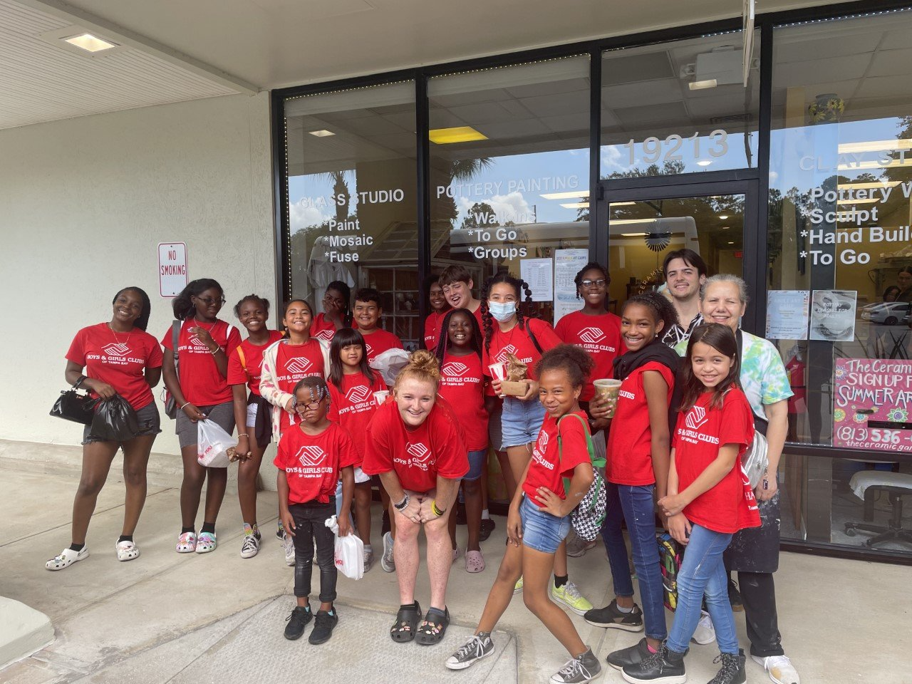 a group of children in red shirts