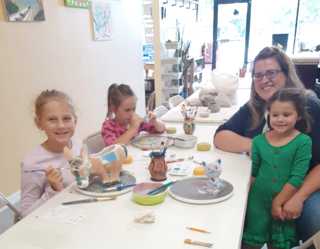 a group of people sitting at a table with a child
