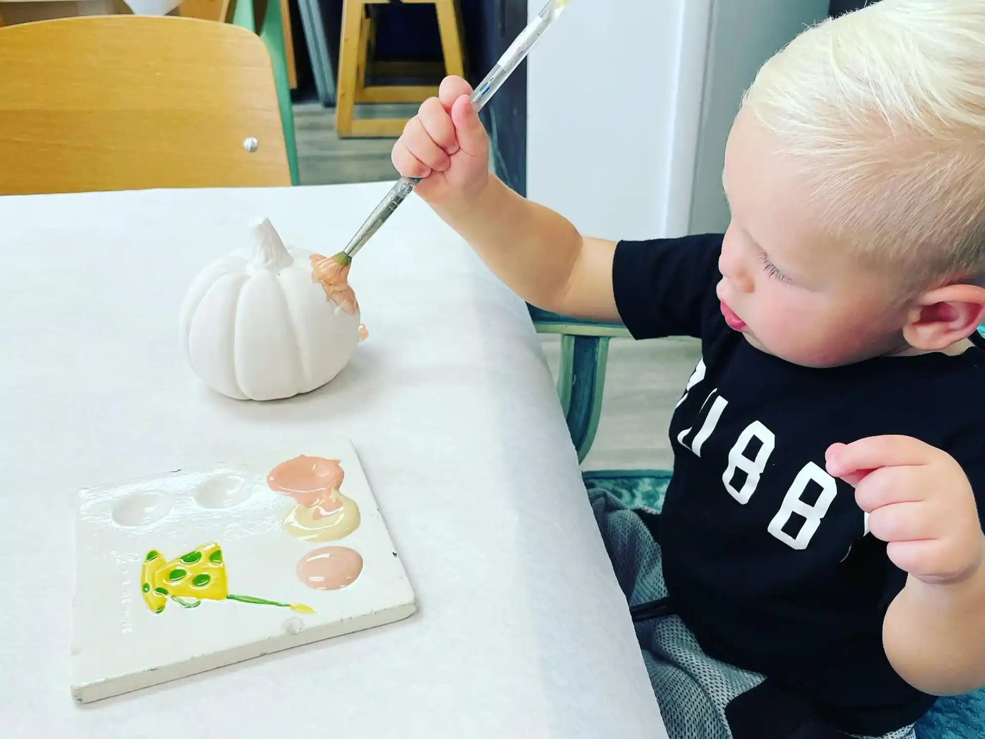 a child painting on a table