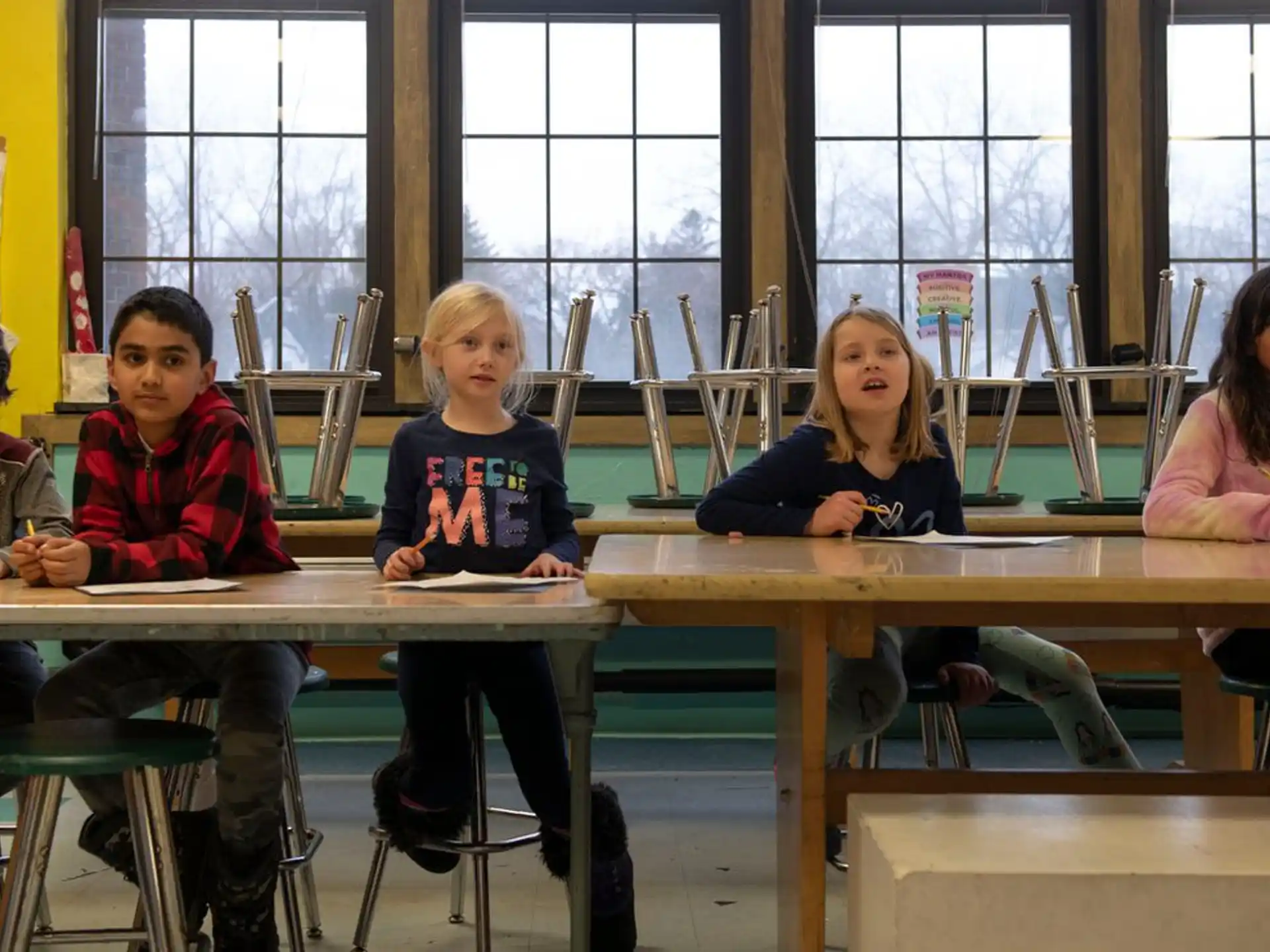 a group of children sitting at a table