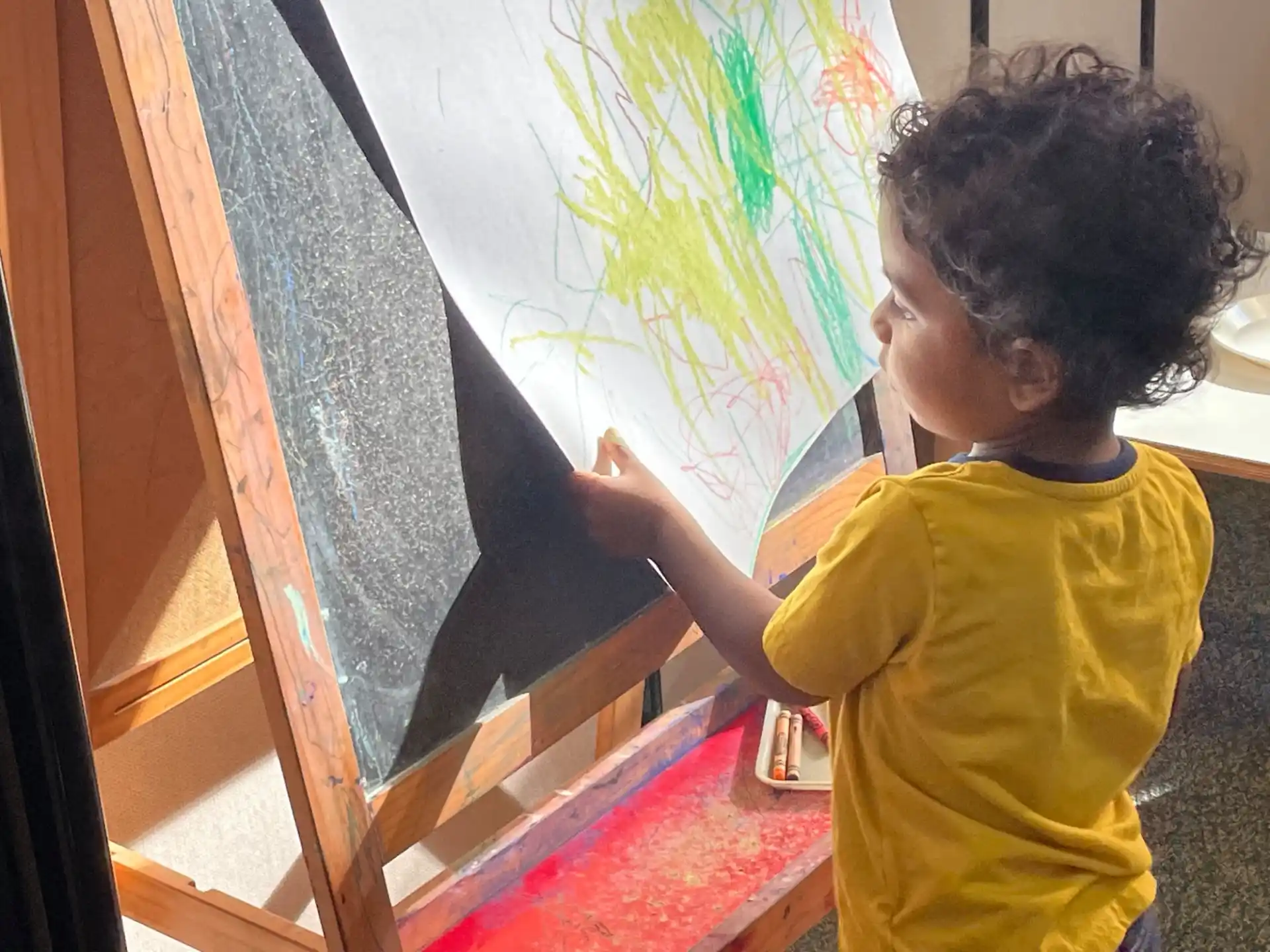 a child painting on a wall