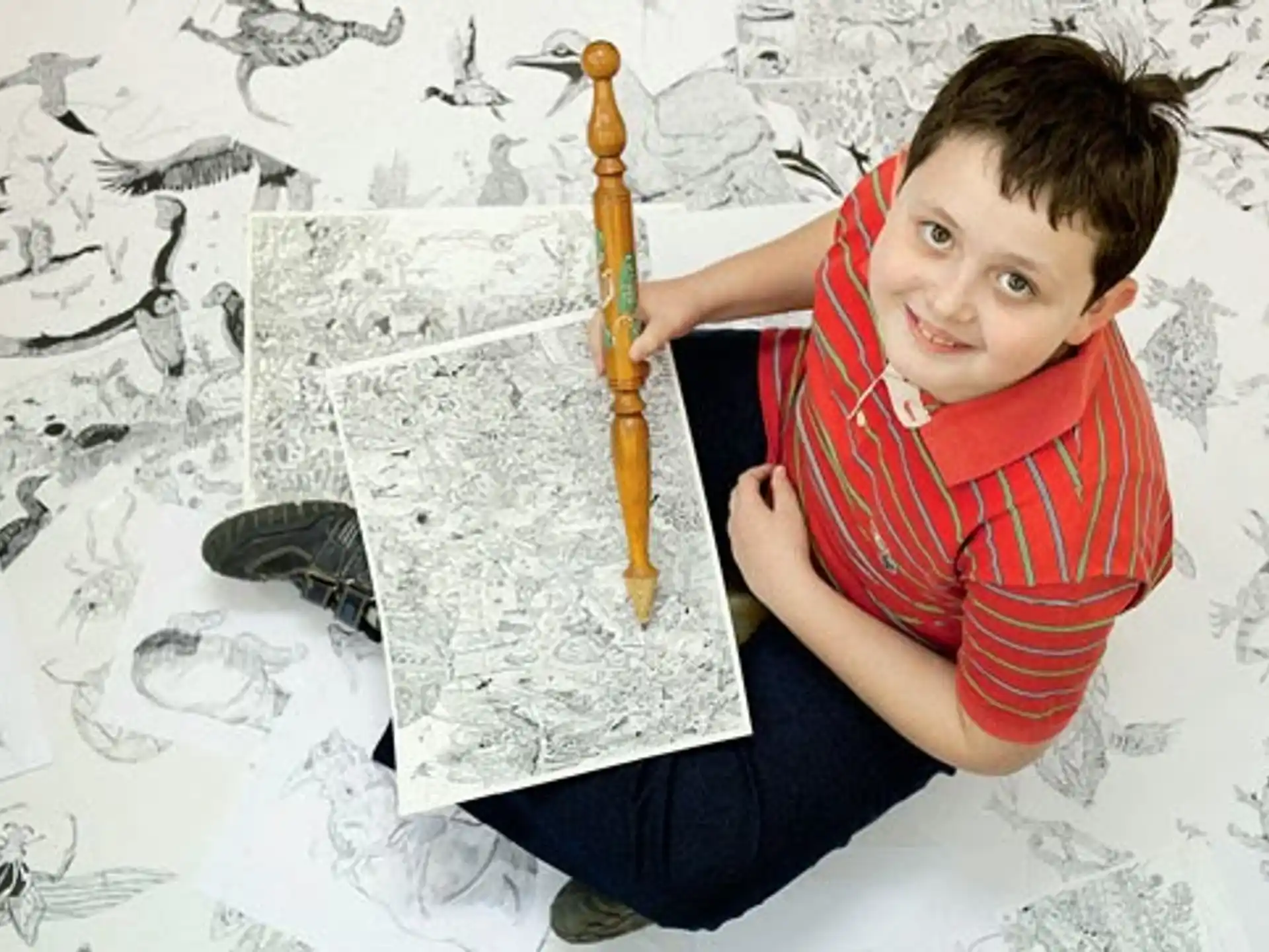 a boy holding a pencil