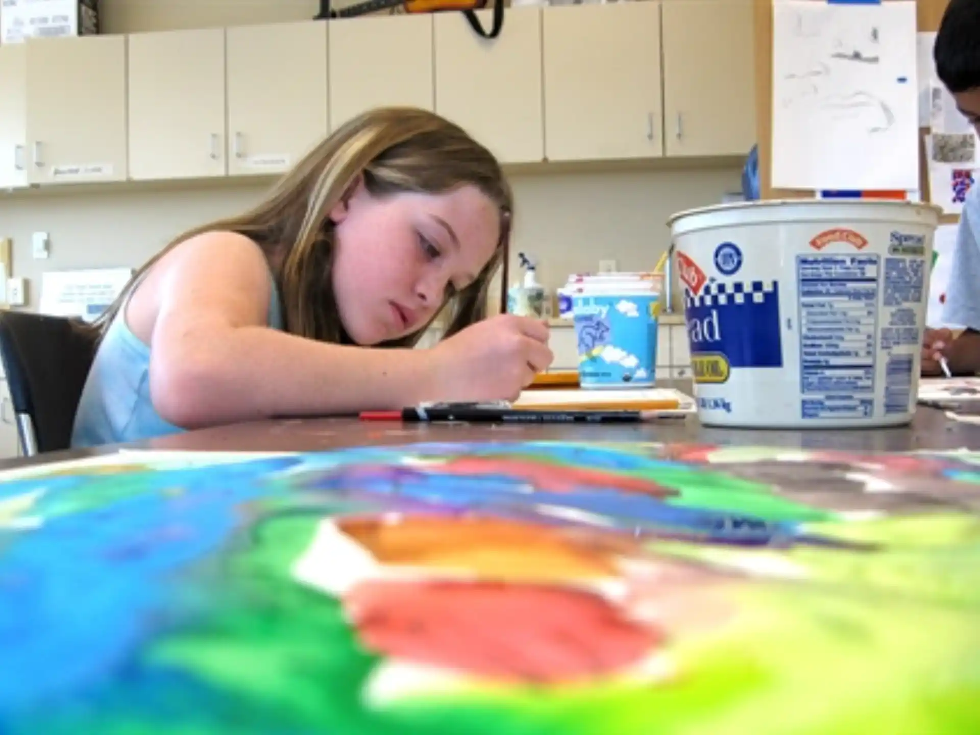a girl painting on a table