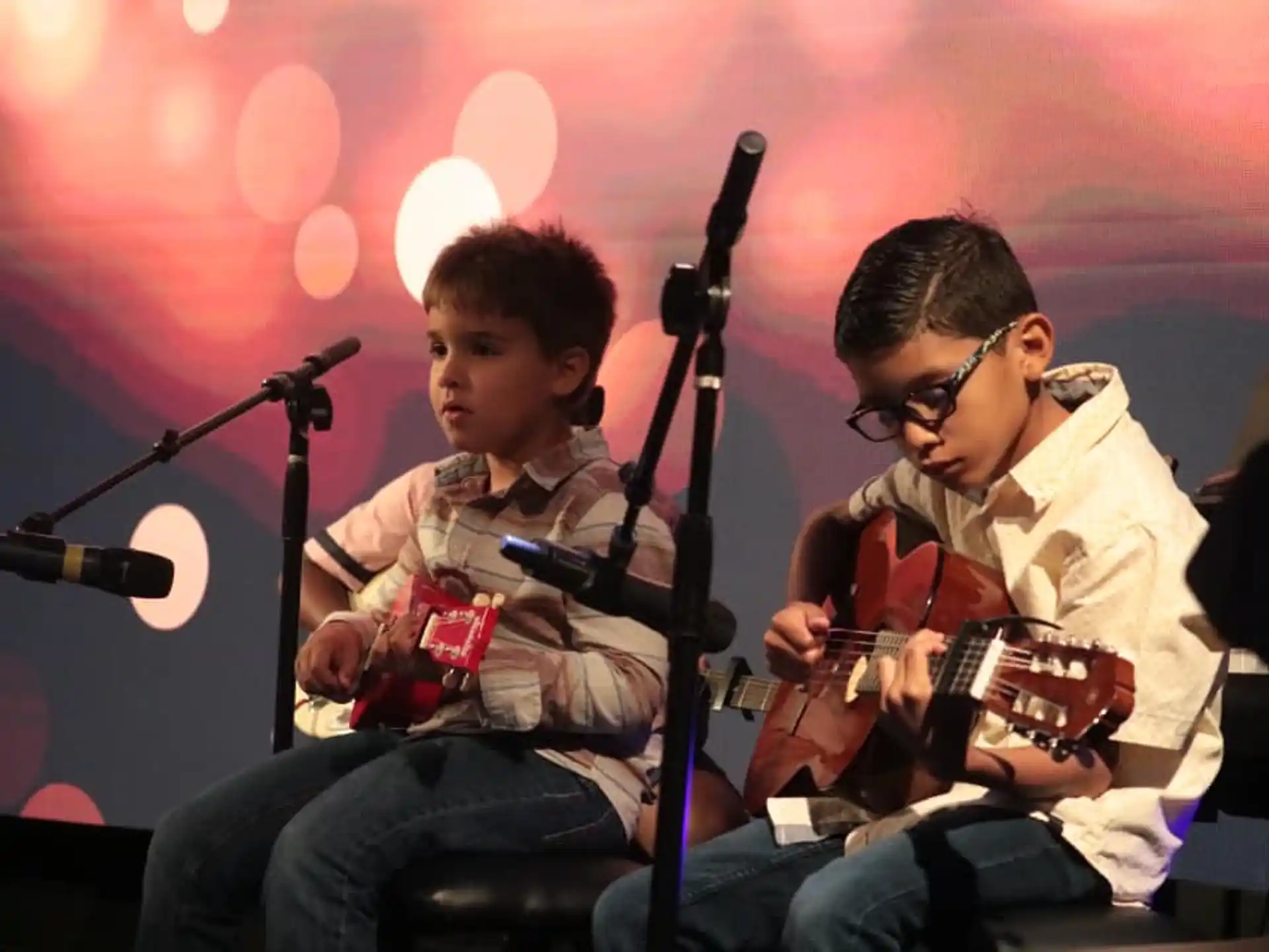 a couple of men playing guitars