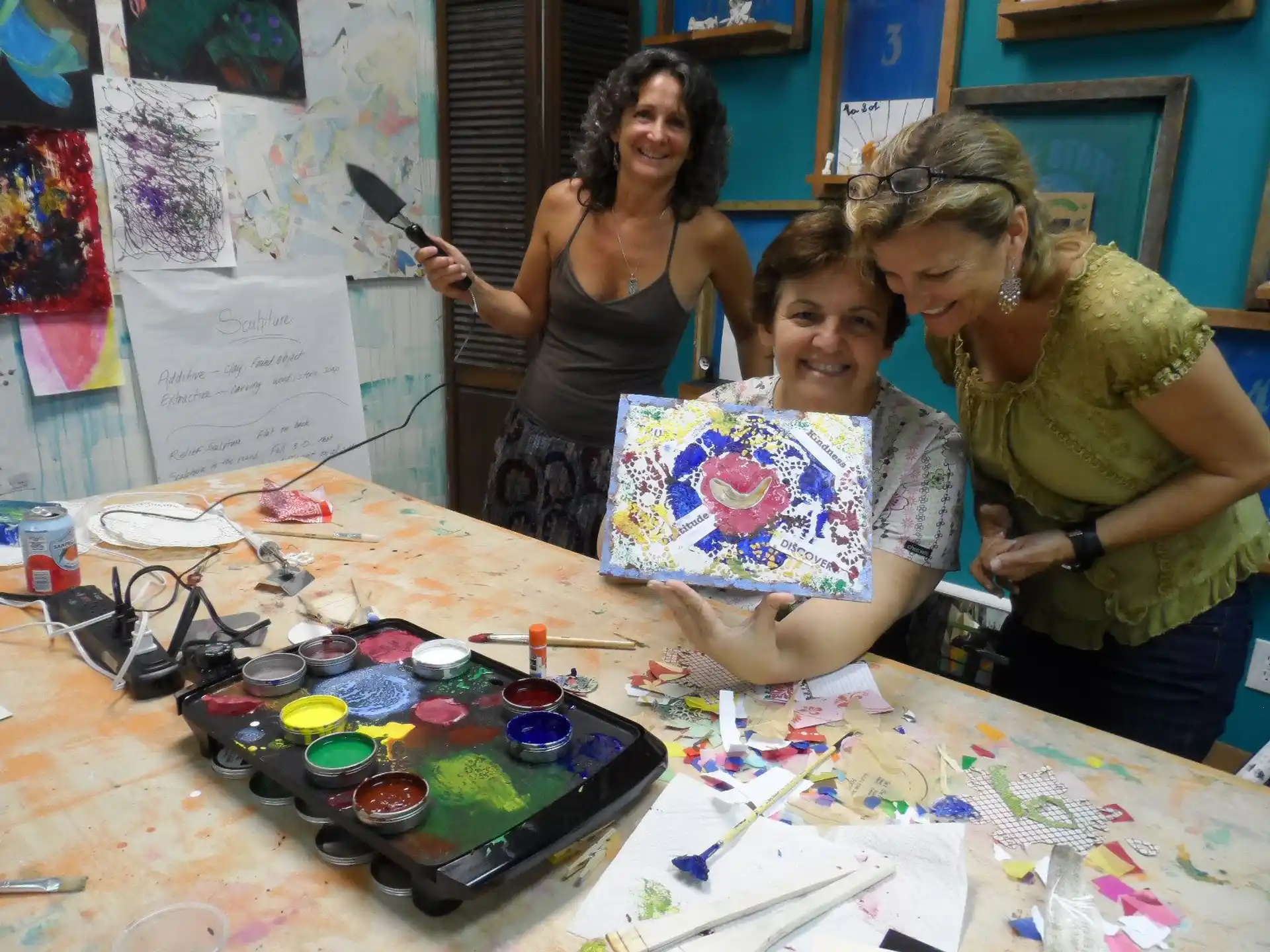 a group of women cutting a cake
