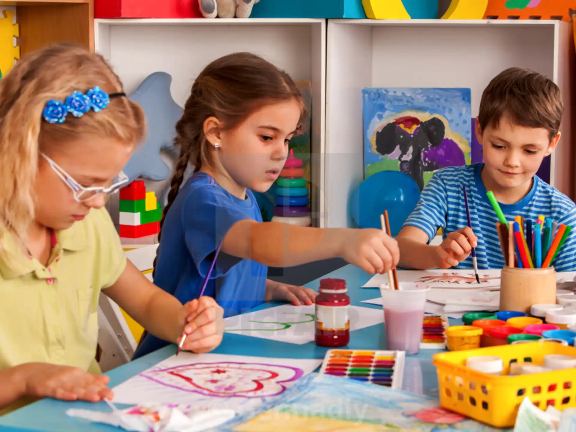 a group of children painting