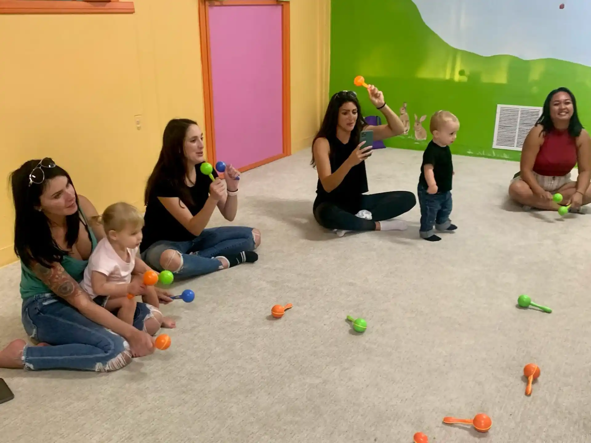 a group of people playing with toys
