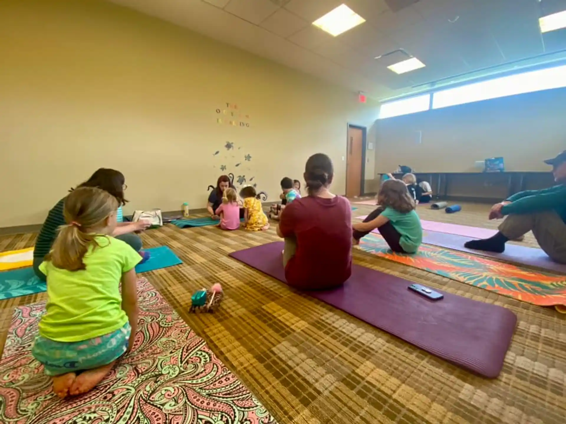 a group of children sitting on mats