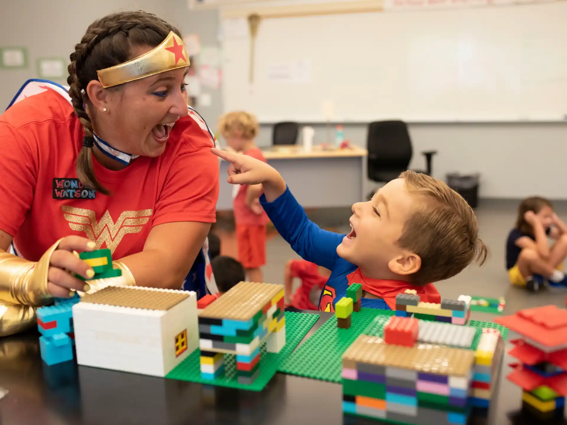 a person and a child playing with building blocks