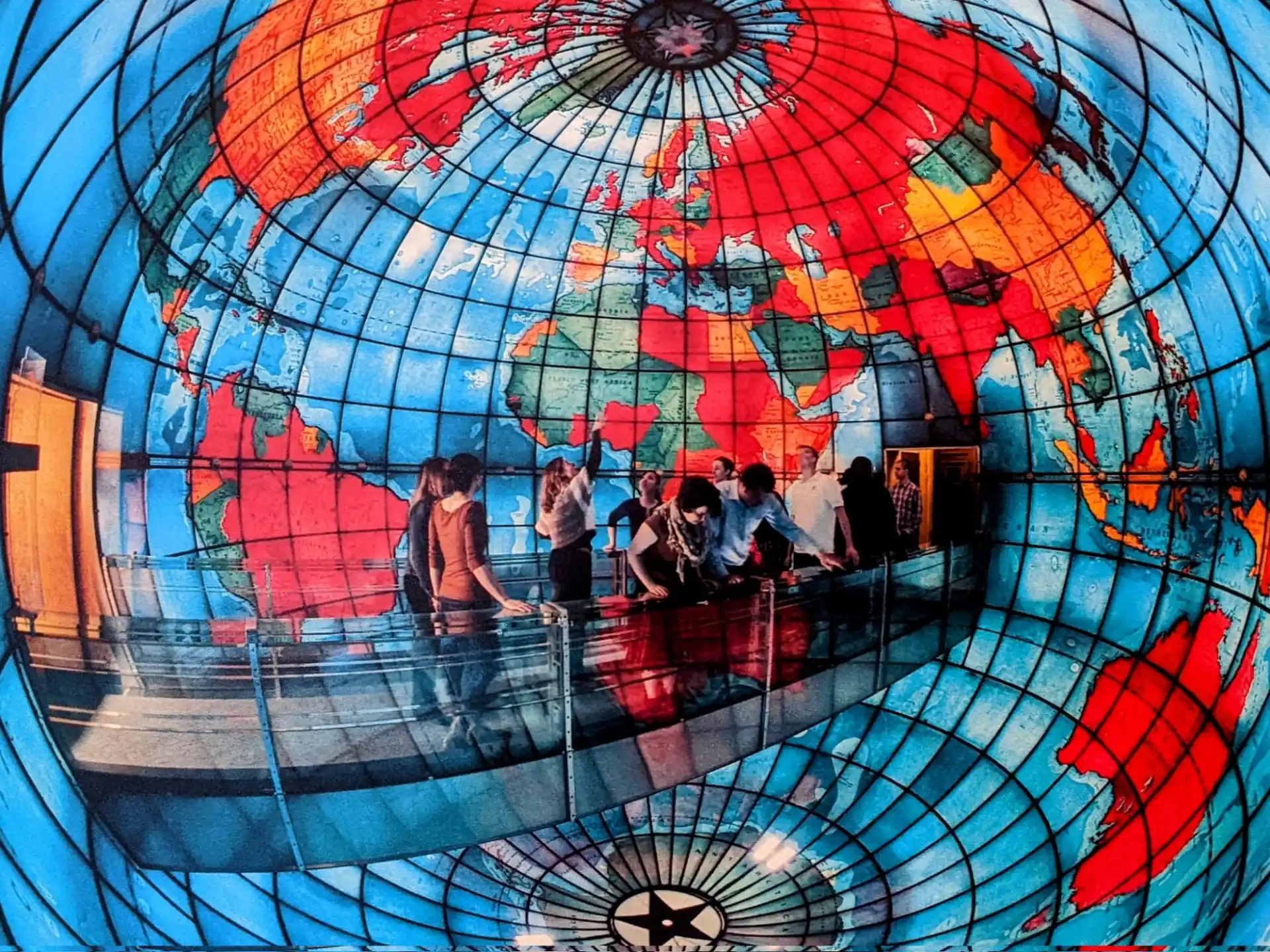 a group of people in a water park with Mapparium in the background