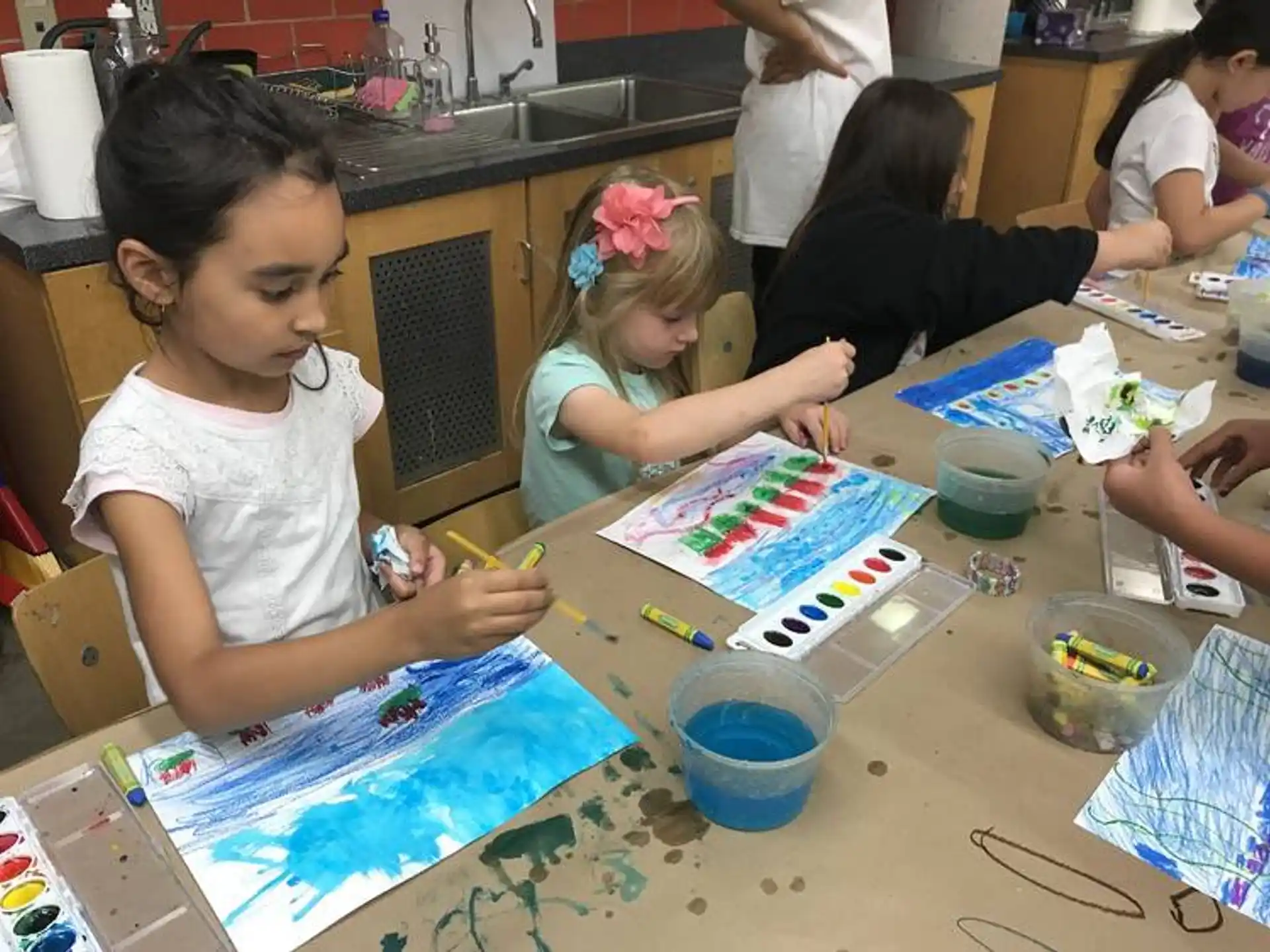 a group of children painting