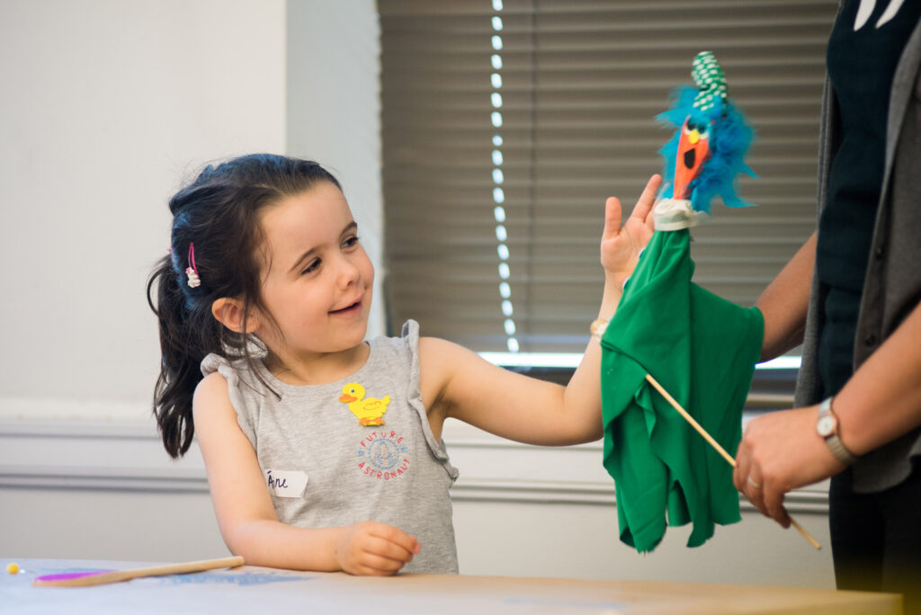 a girl holding a toy