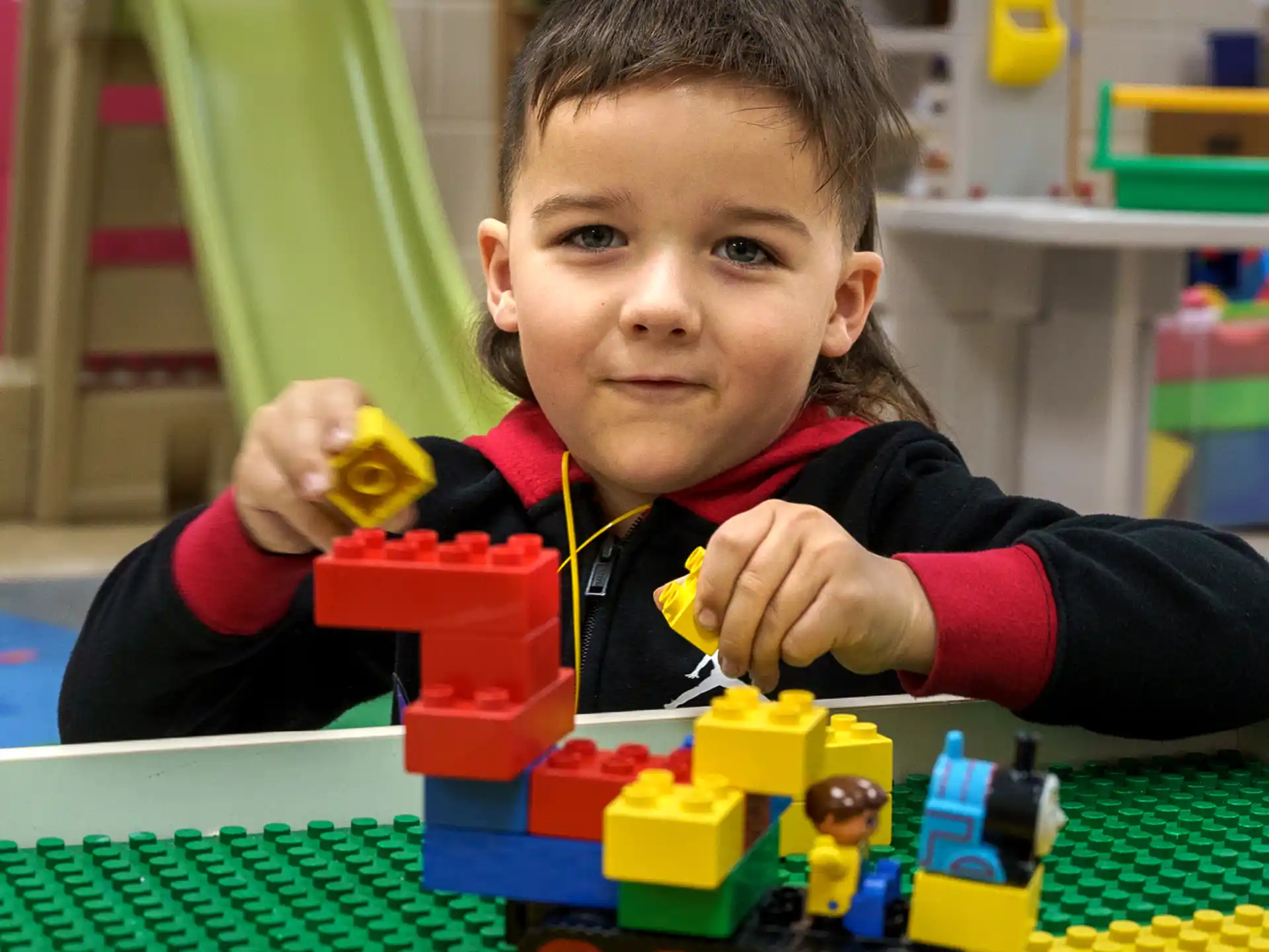 a child playing with a toy train